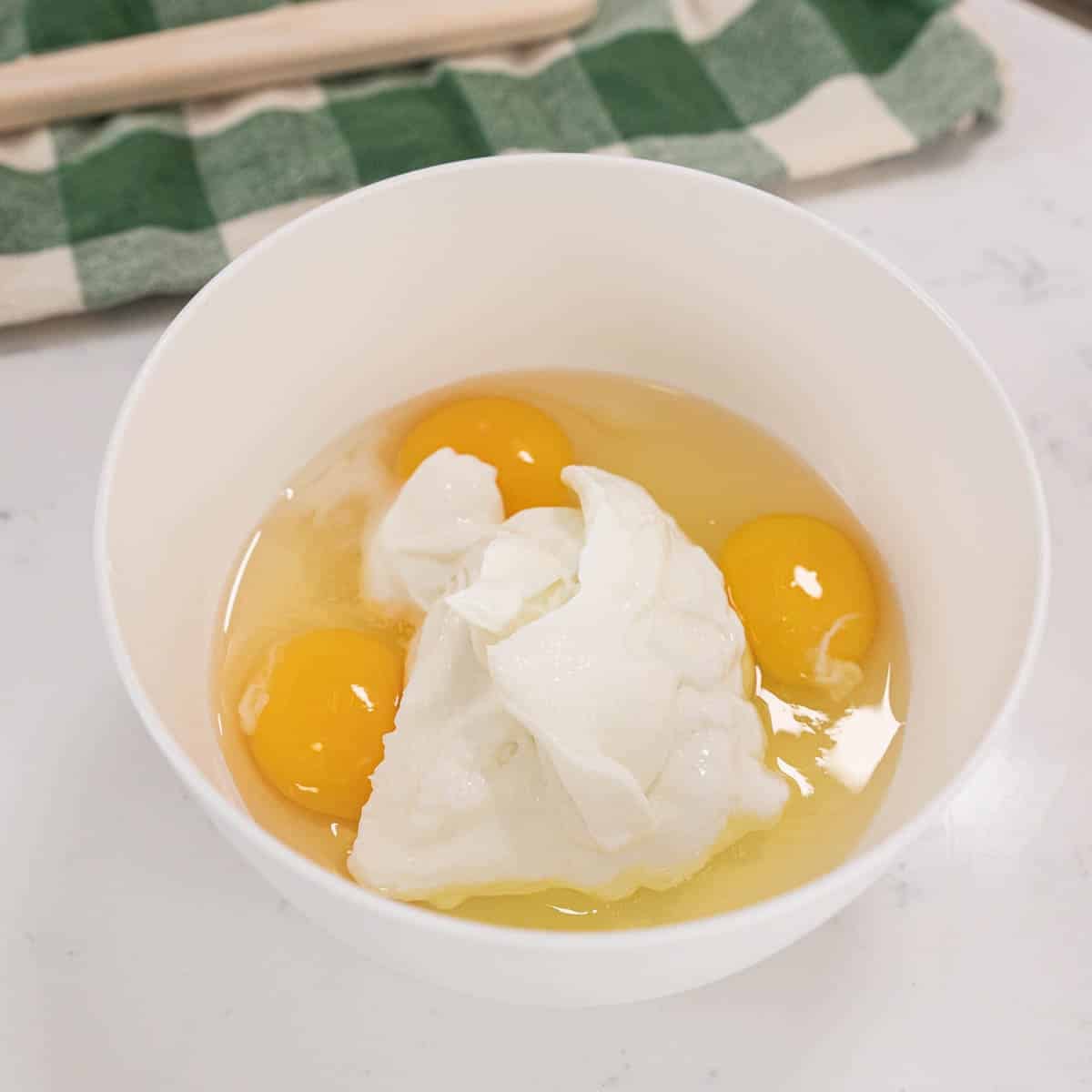 sour cream and egg mixture in a white bowl