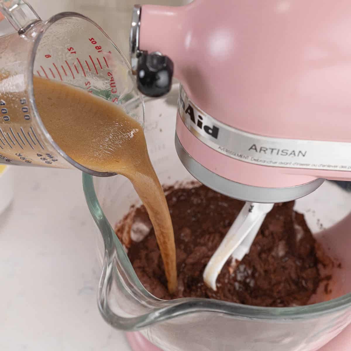 Adding beer mixture to cocoa powder mixture in a stand mixer