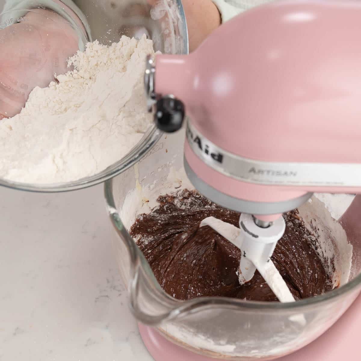 adding flour mixture to cocoa mixture in a stand mixer