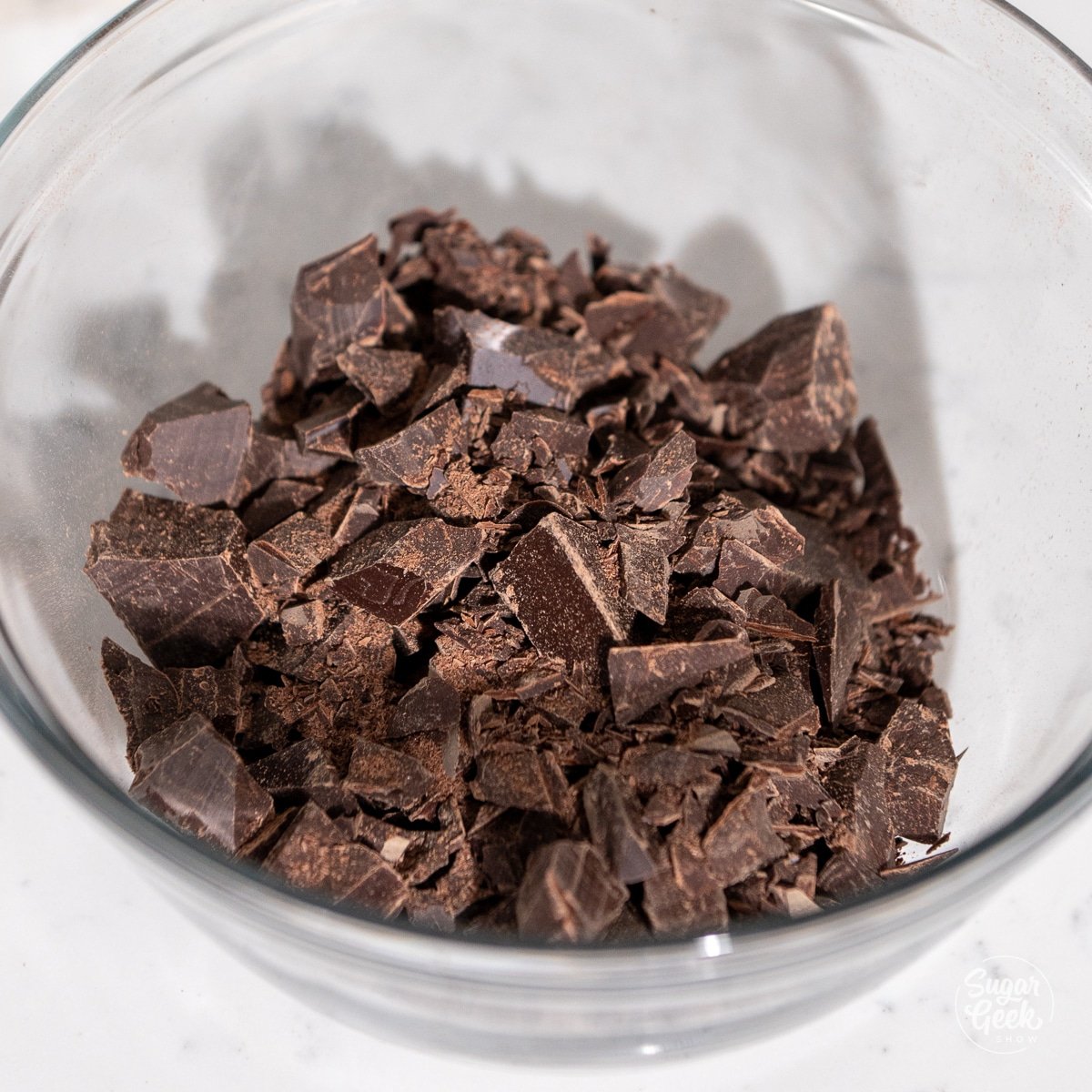 chopped dark chocolate in a glass bowl