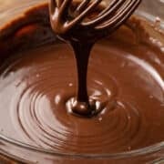 close up of ganache drizzling into a bowl