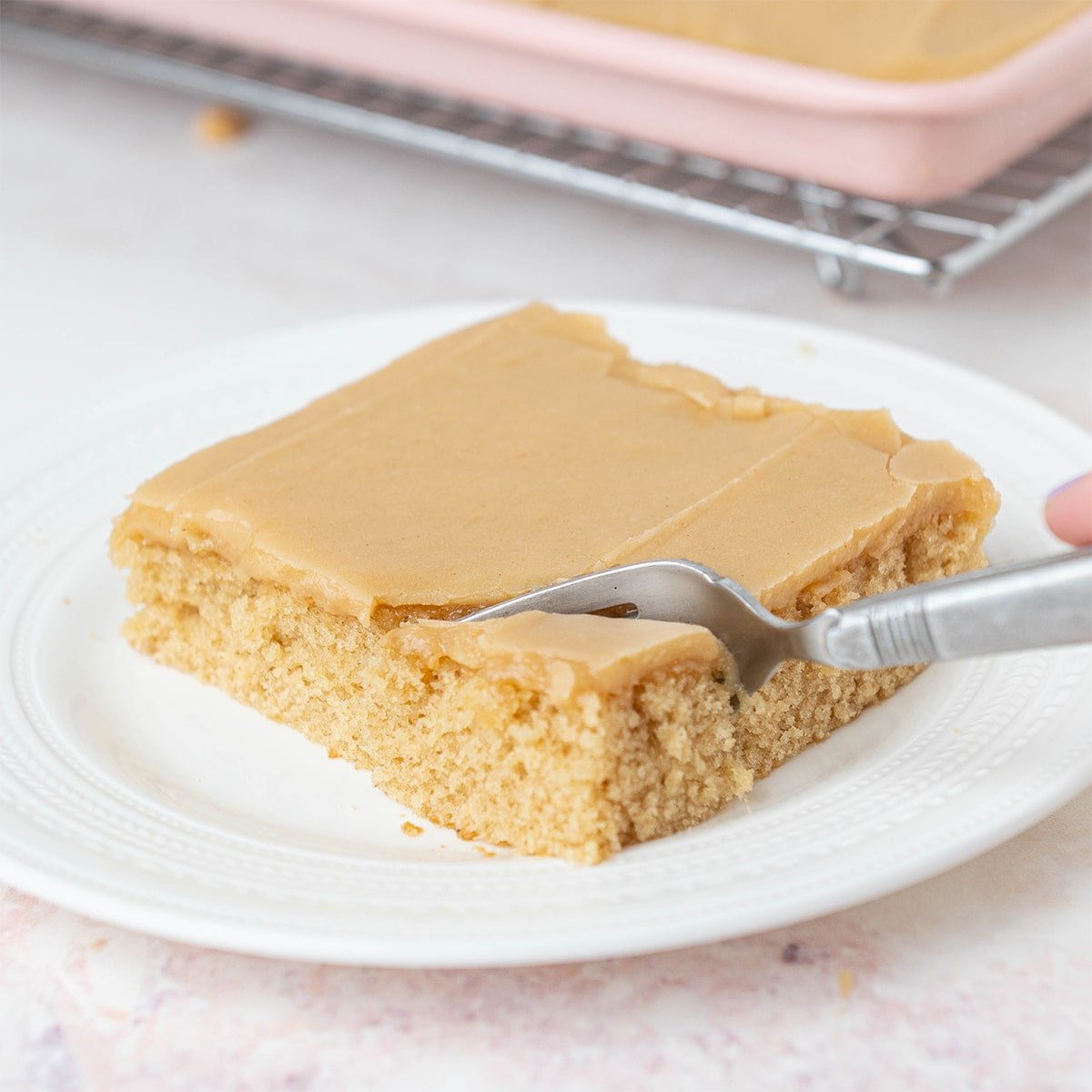 fork going through a slice of peanut butter sheet cake