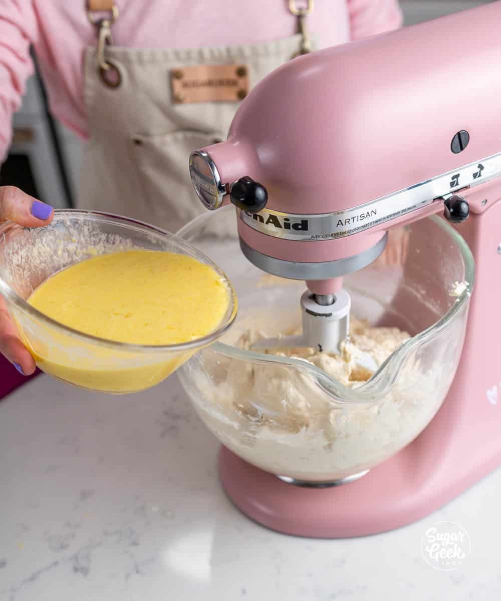adding egg mixture to a stand mixer bowl