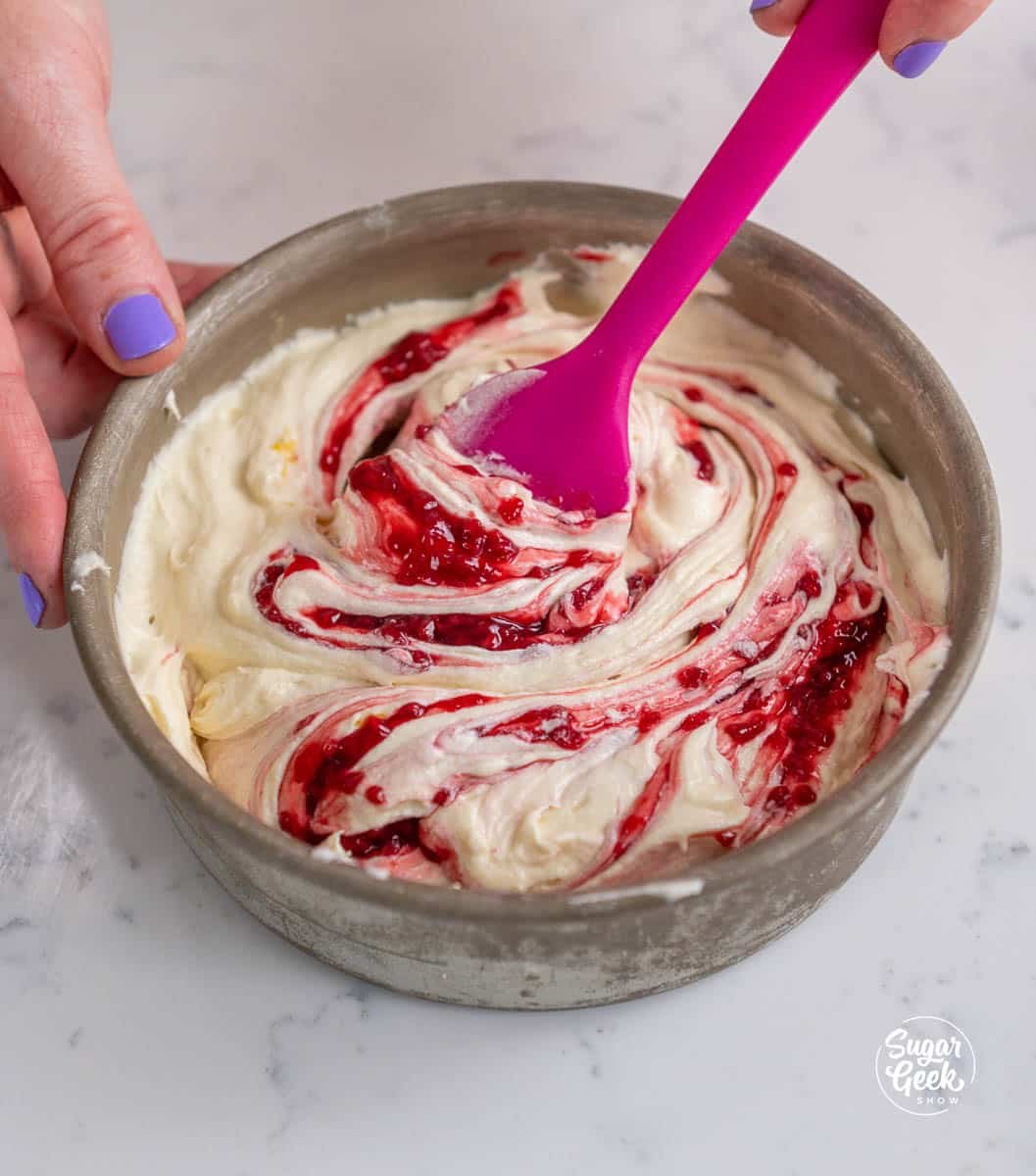 swirling raspberry puree into cake batter