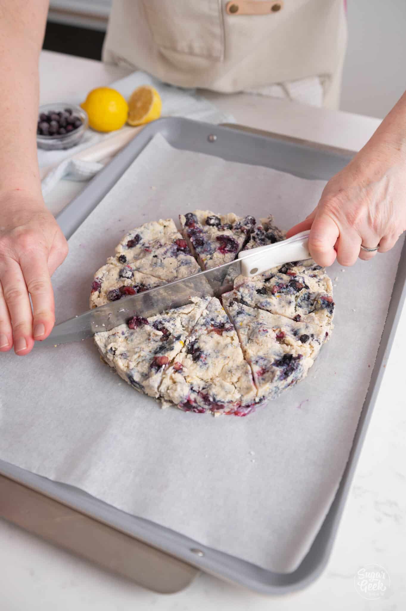 cutting a disc of scone dough with a knife