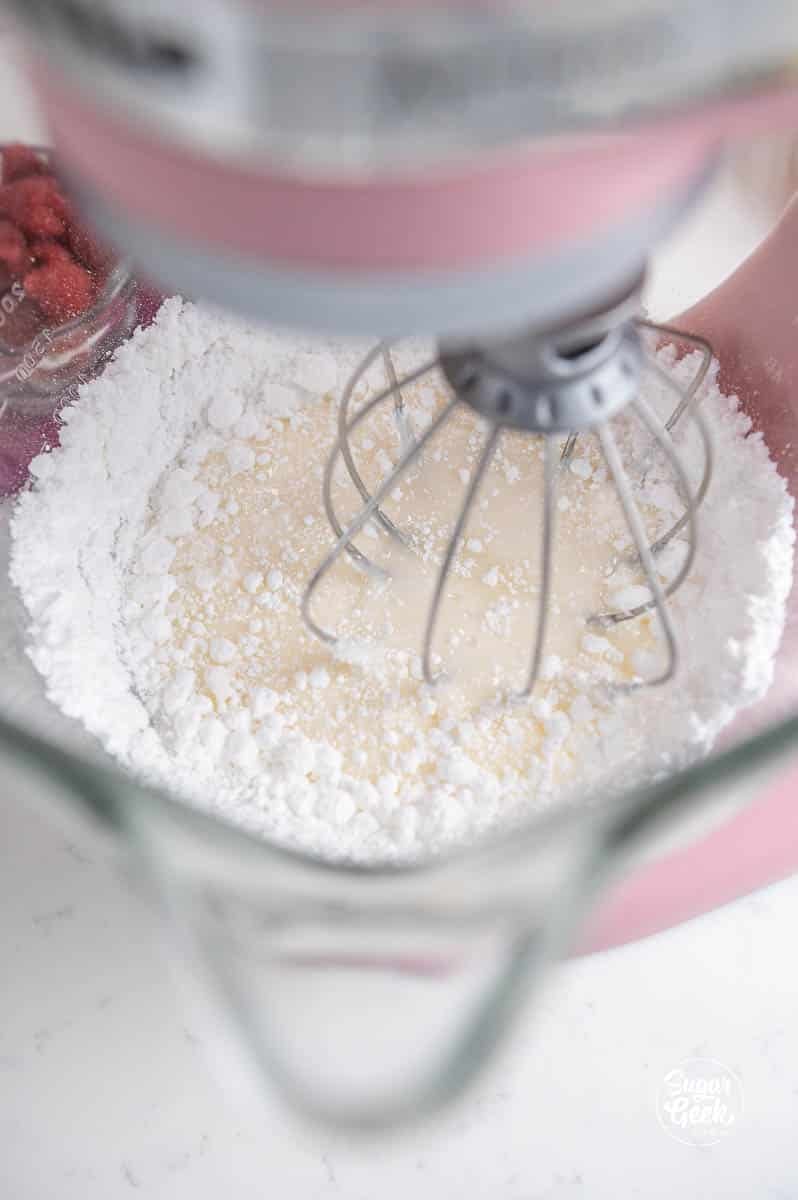 egg whites and powdered sugar in a stand mixer bowl