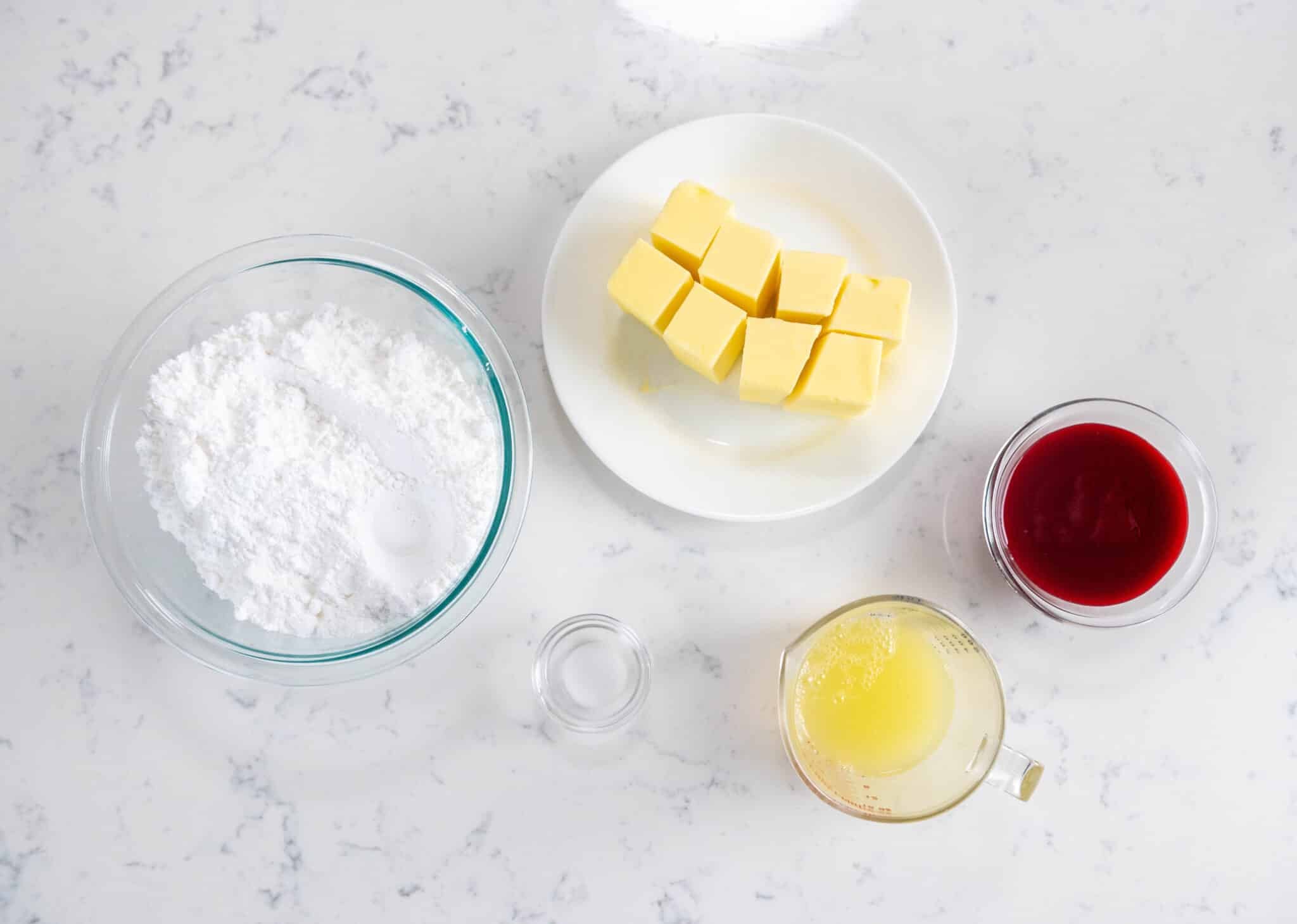 Ingredients in glass bowls on a white countertop.