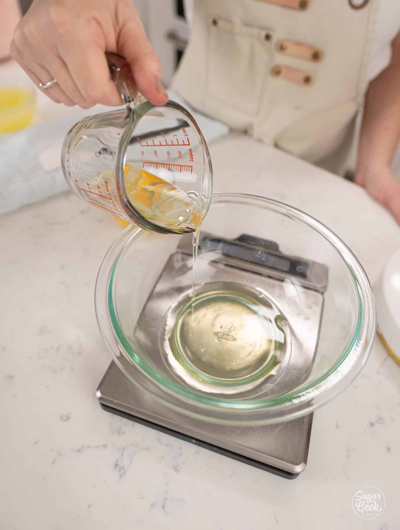 pouring egg whites into a bowl
