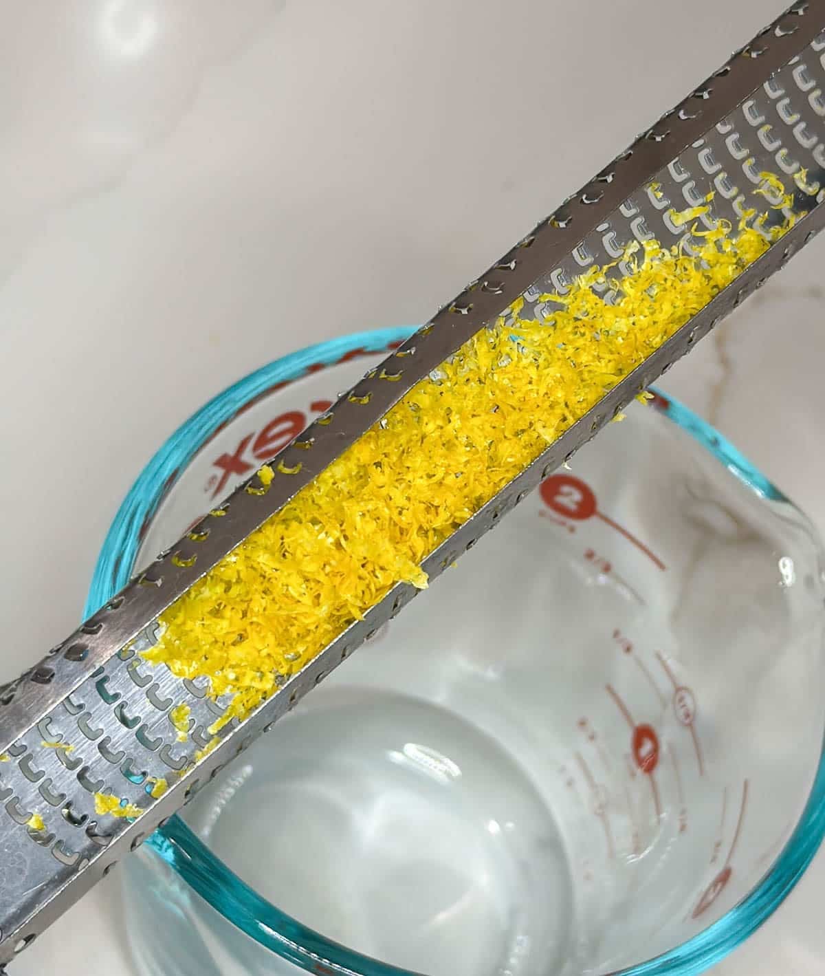 Close up of lemon zest on a zester.