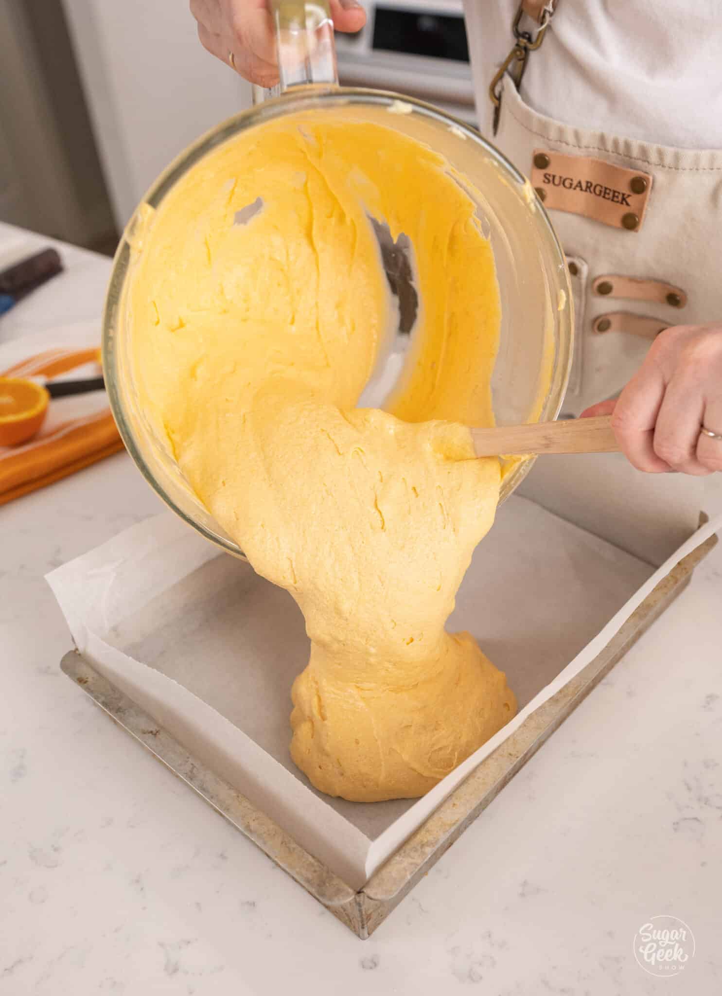 pouring cake batter into a pan