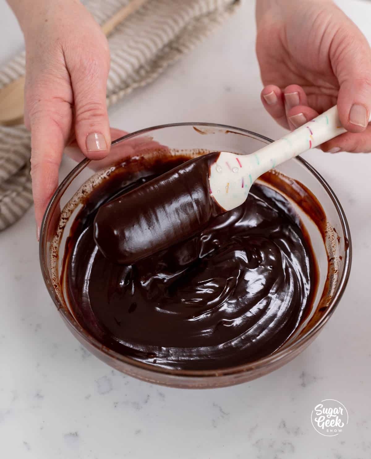 mixing a bowl of chocolate with a spatula