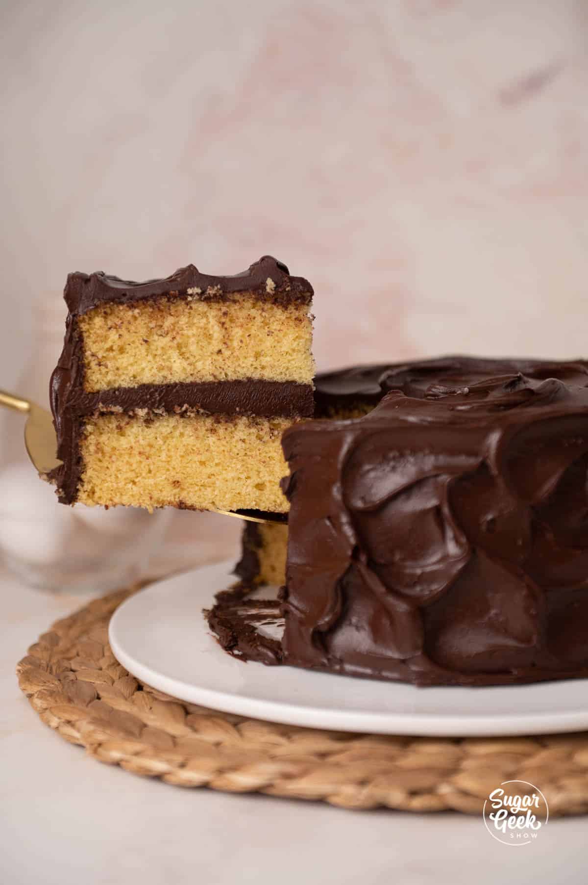 slice of yellow cake coming out of a whole cake