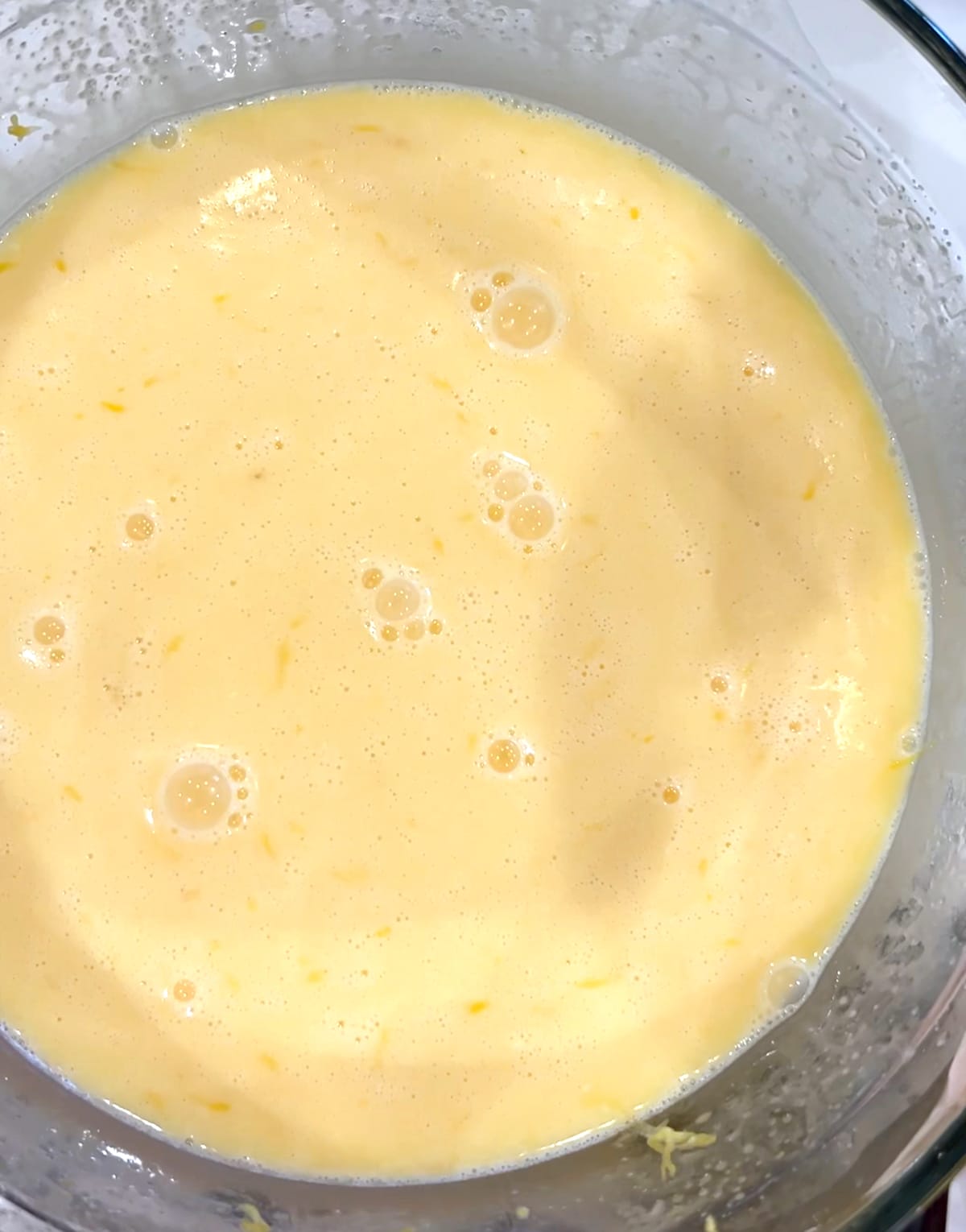 blended lemon tart filling in a clear bowl