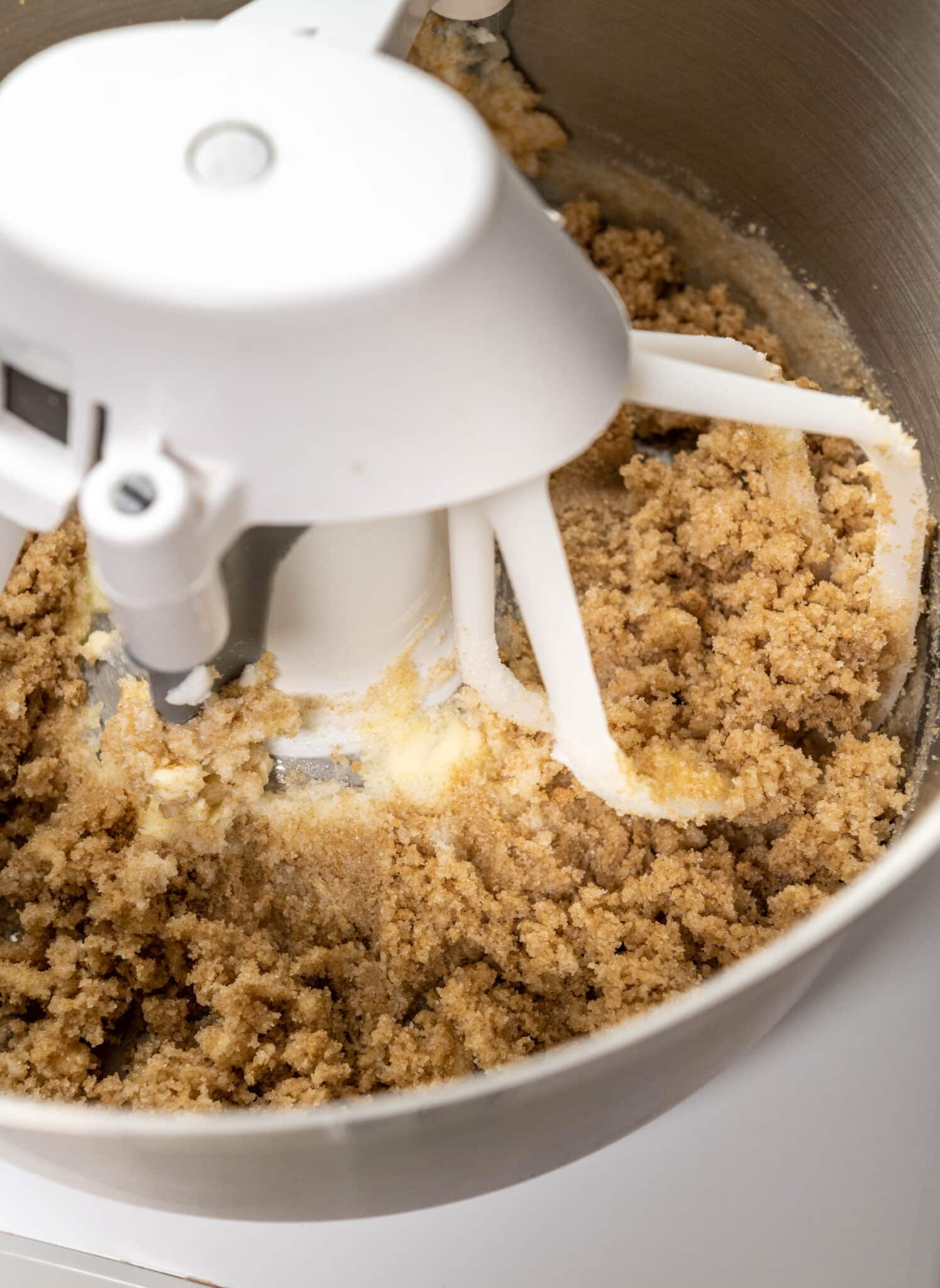 close up of oatmeal raisin m&m cookie ingredients in the bowl of a stand mixer