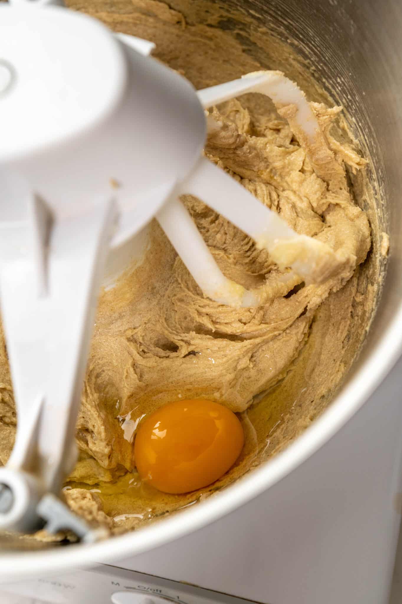 close up of adding eggs to the oatmeal cookie mixture