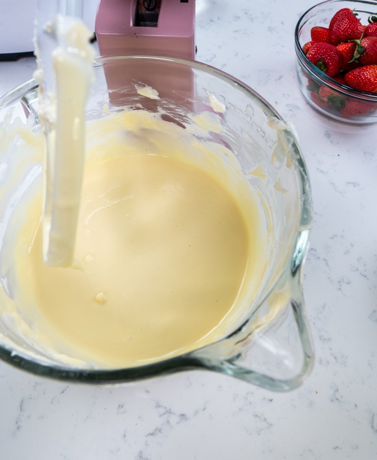 close up of finished cheesecake filling in the bowl of a stand mixer