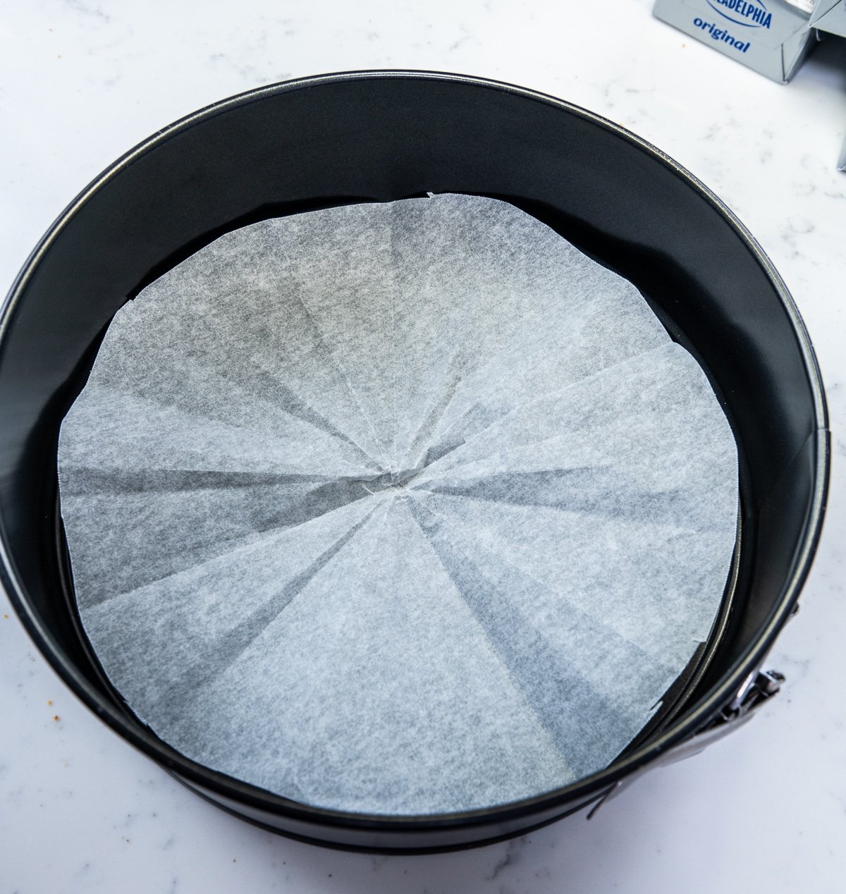 parchment paper in the base of a cheesecake pan