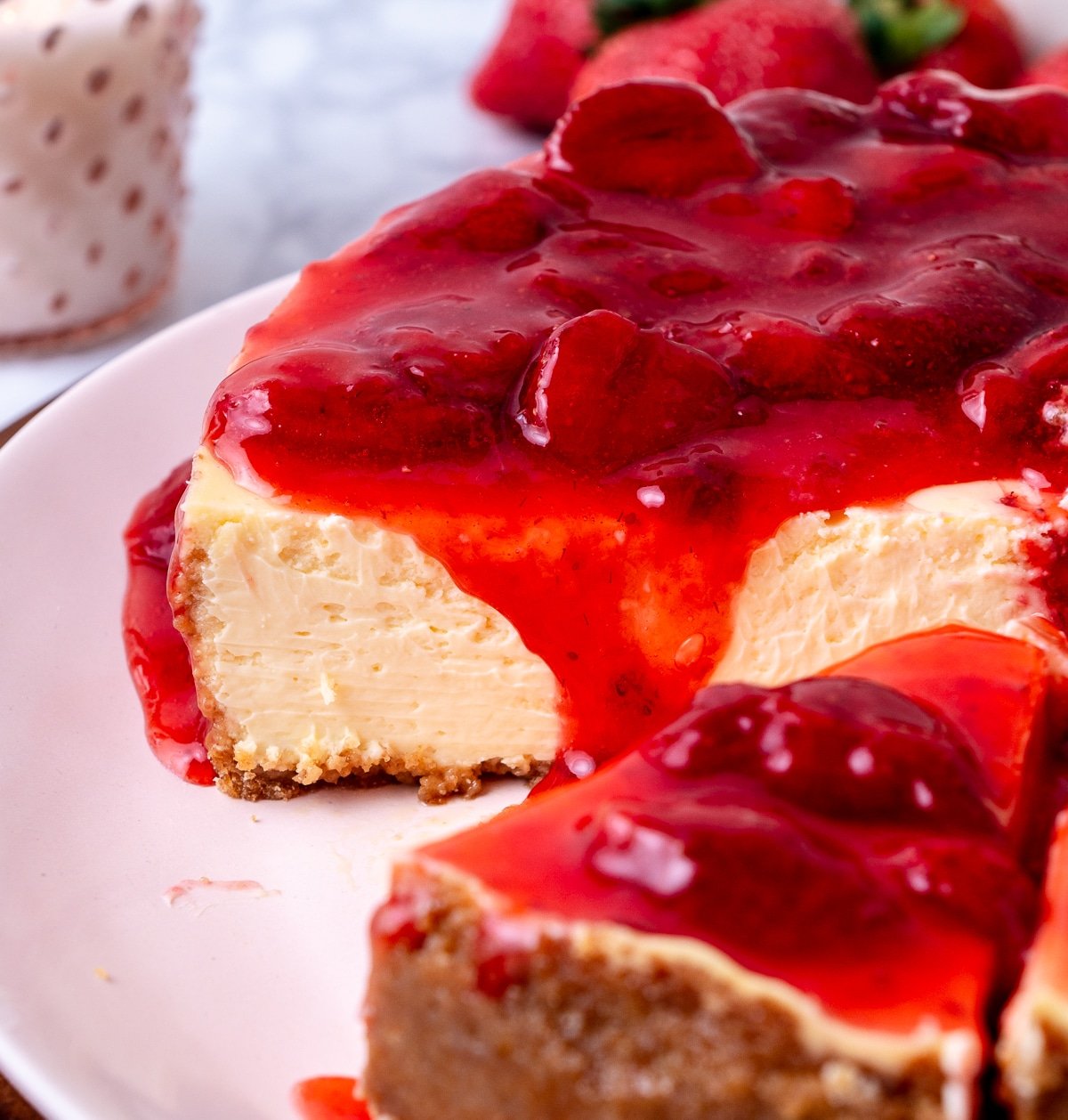 close up of cheesecake with strawberry topping