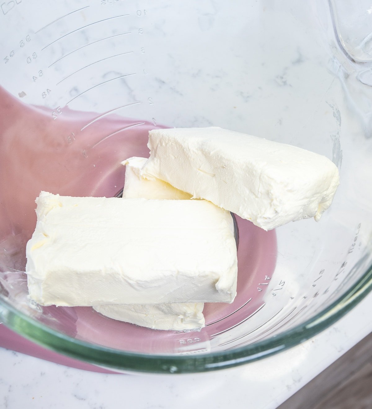 close up of cream cheese in the bowl of your stand mixer