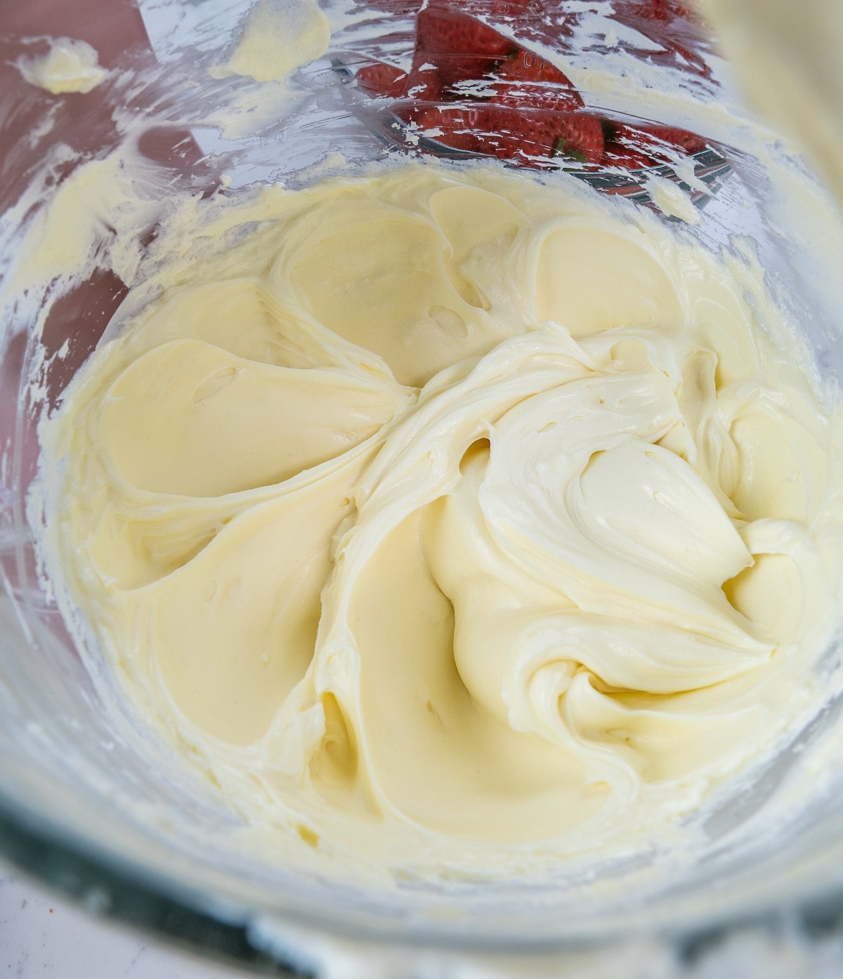 close up of cream cheese mixture in the bowl of a stand mixer