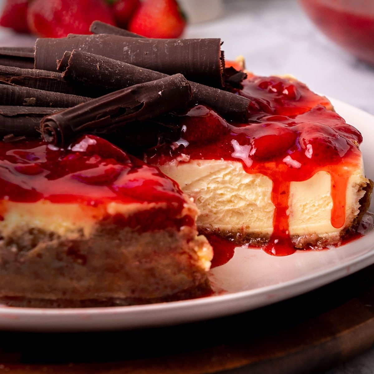 close up of cherry cheesecake with chocolate curls on top