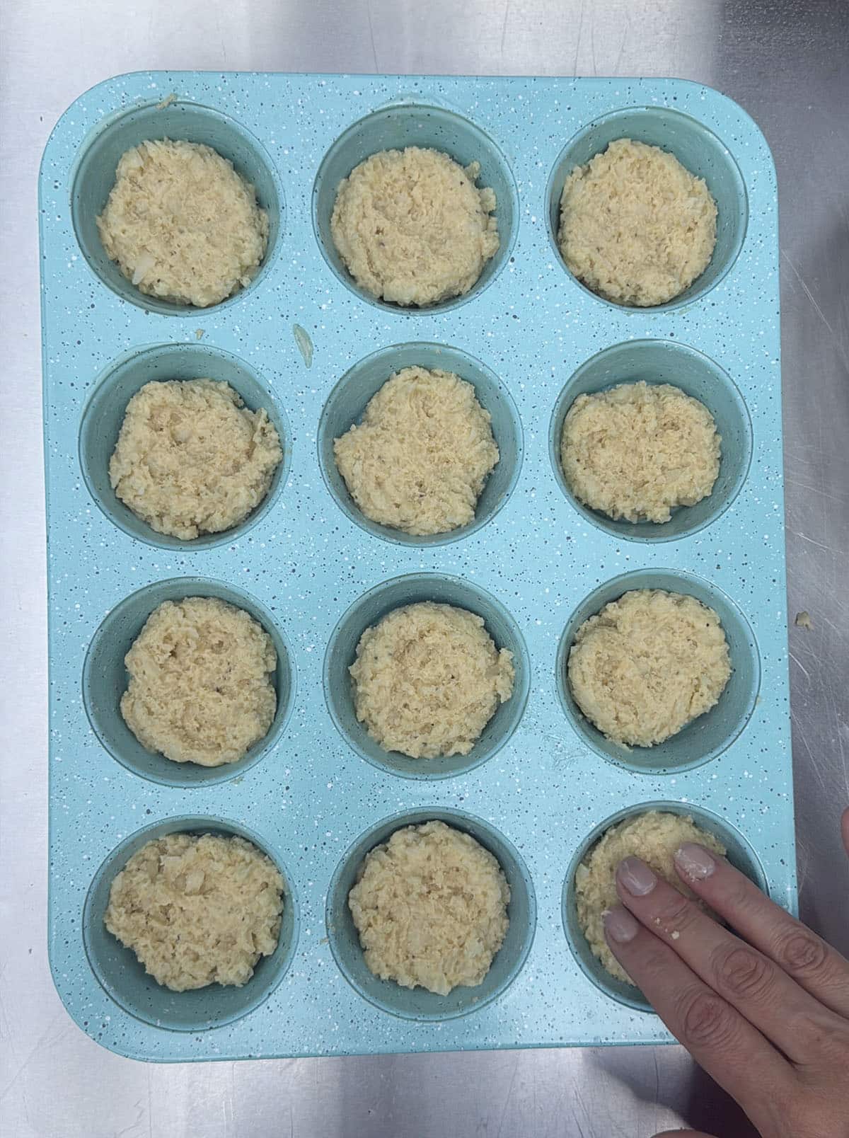 keto biscuit dough in a muffin pan