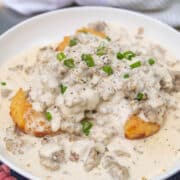 close up of sausage gravy on biscuits