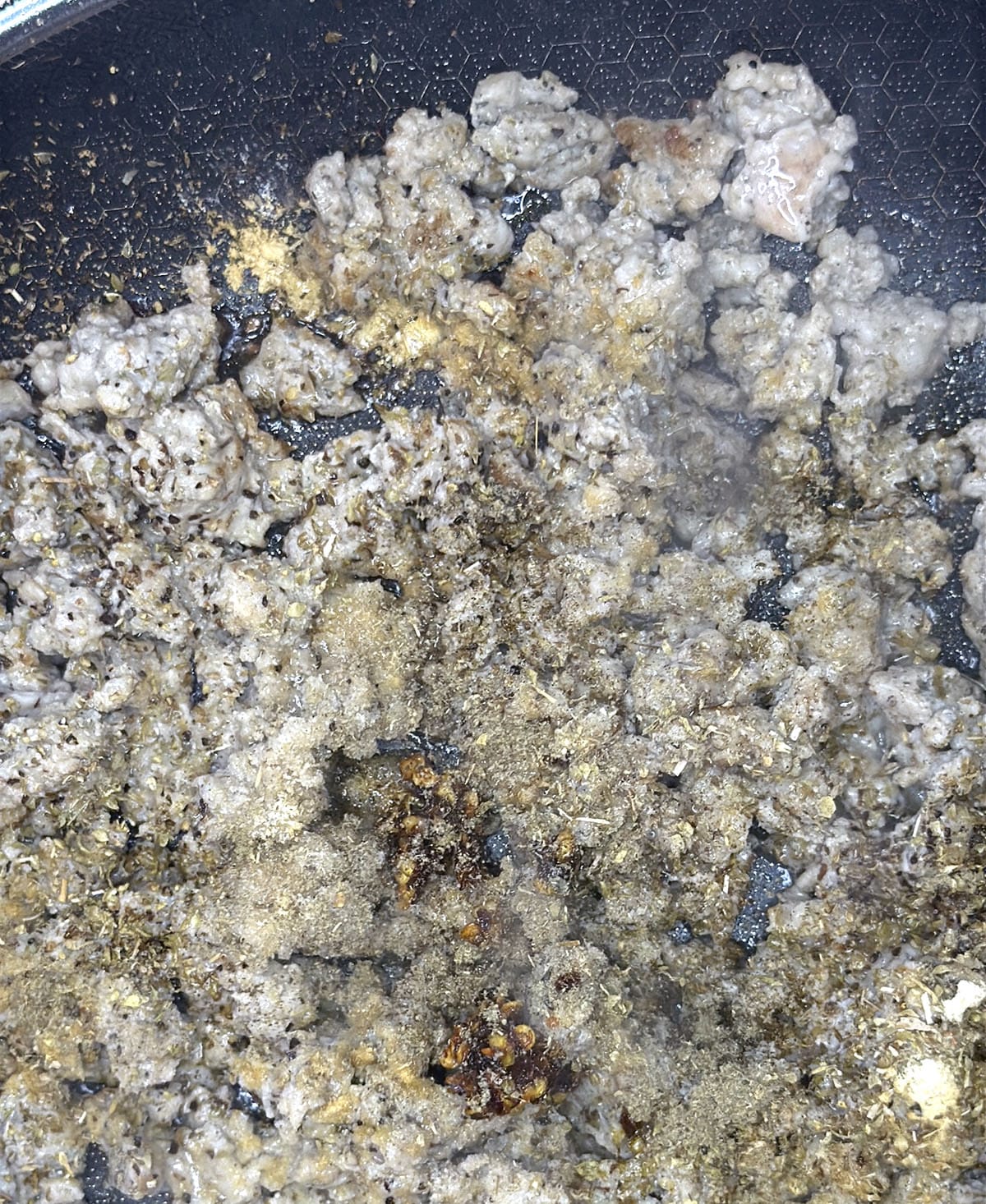 close up of cooking sausage with spices