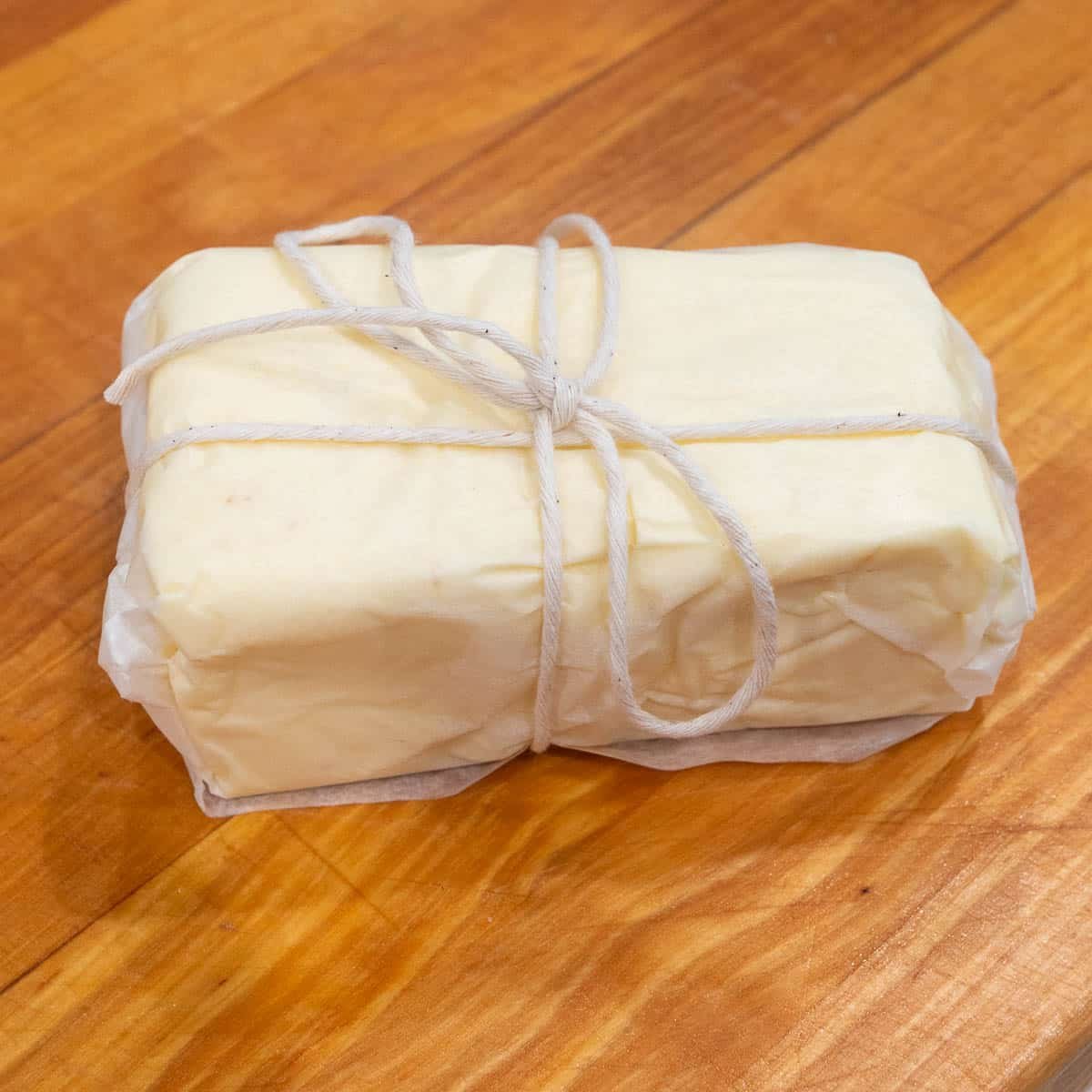 homemade french butter wrapped in parchment paper and butchers twine