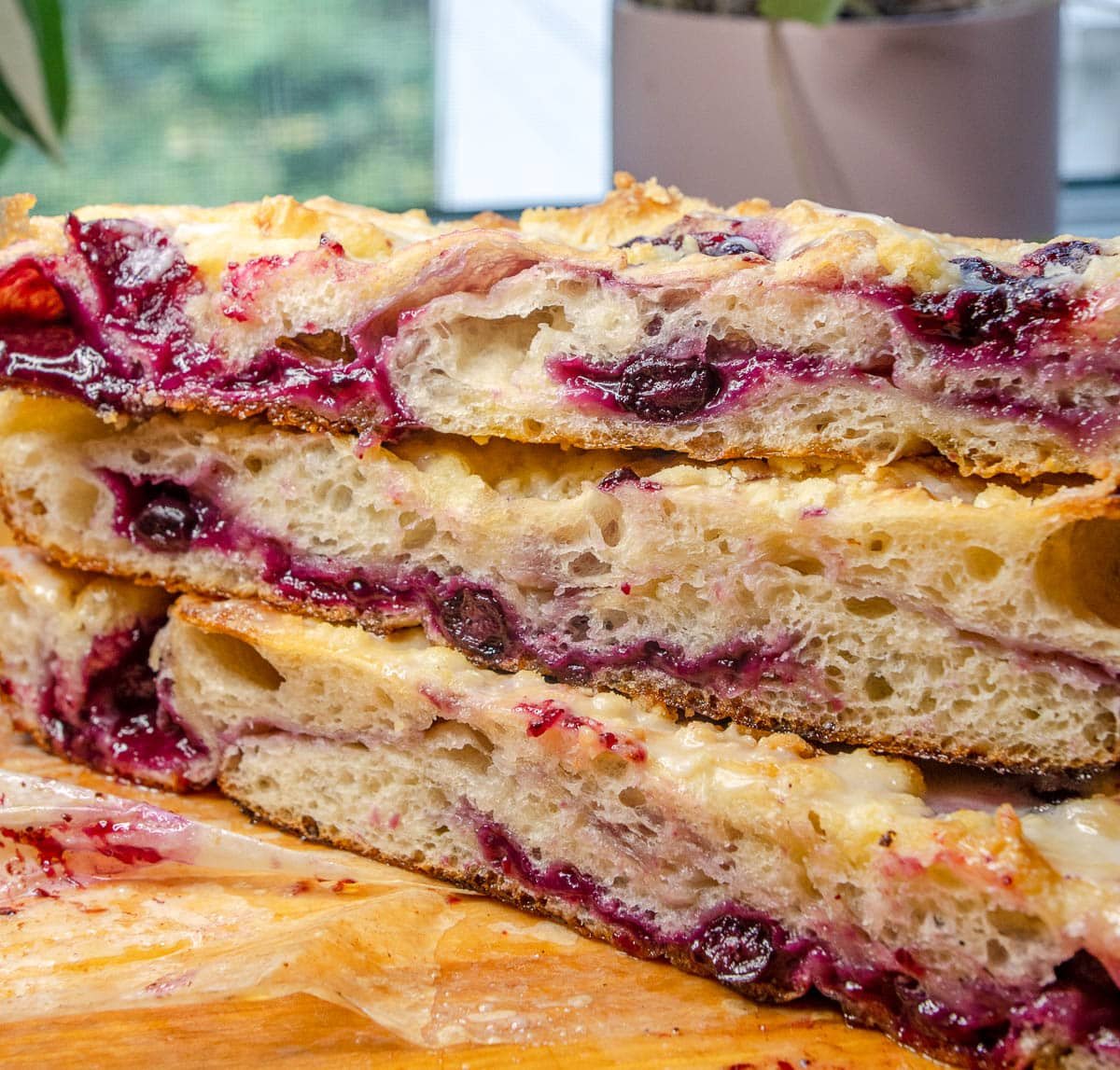 close up of lemon raspberry sourdough focaccia stacked 