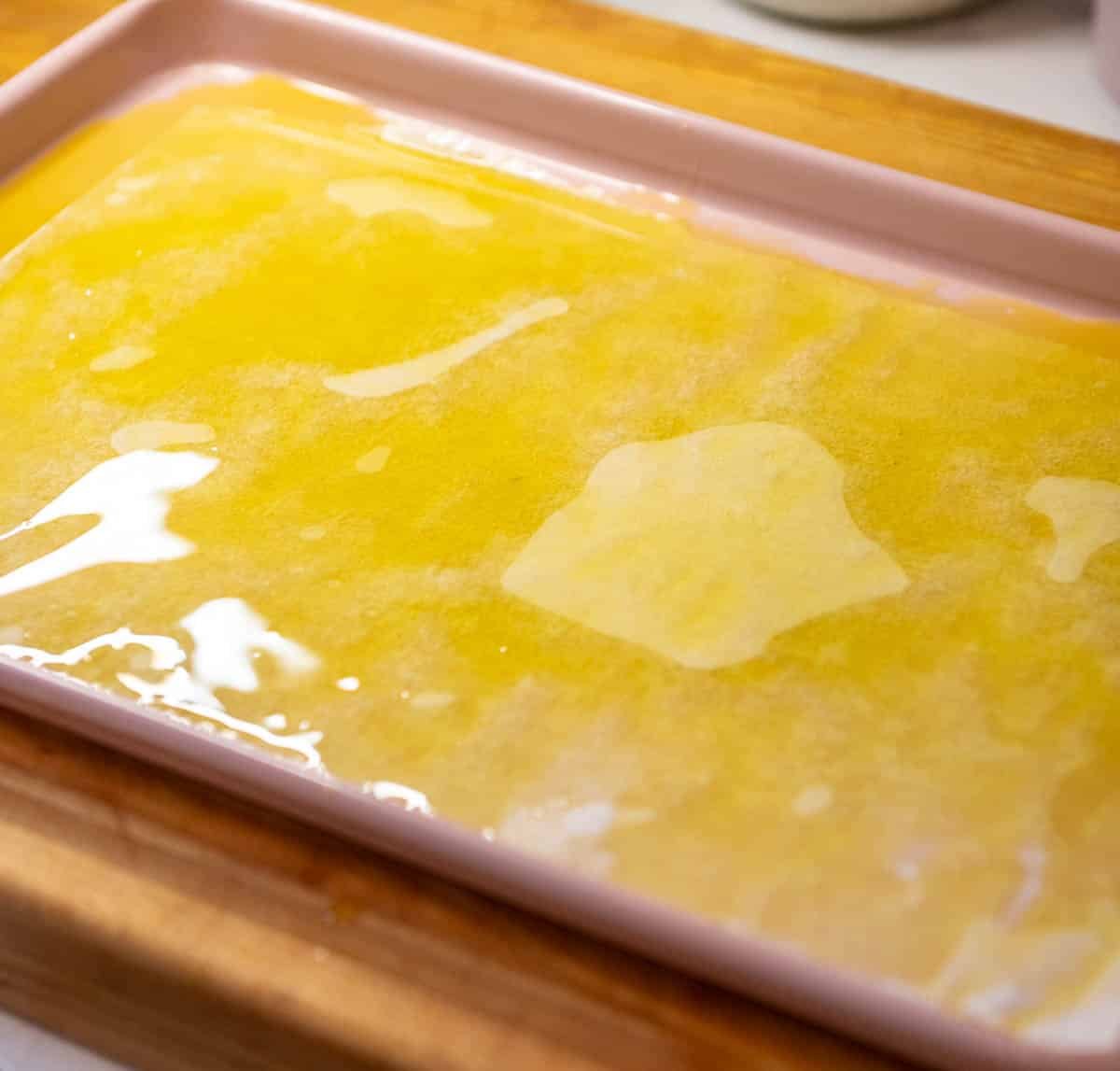 olive oil and melted butter on a sheet pan