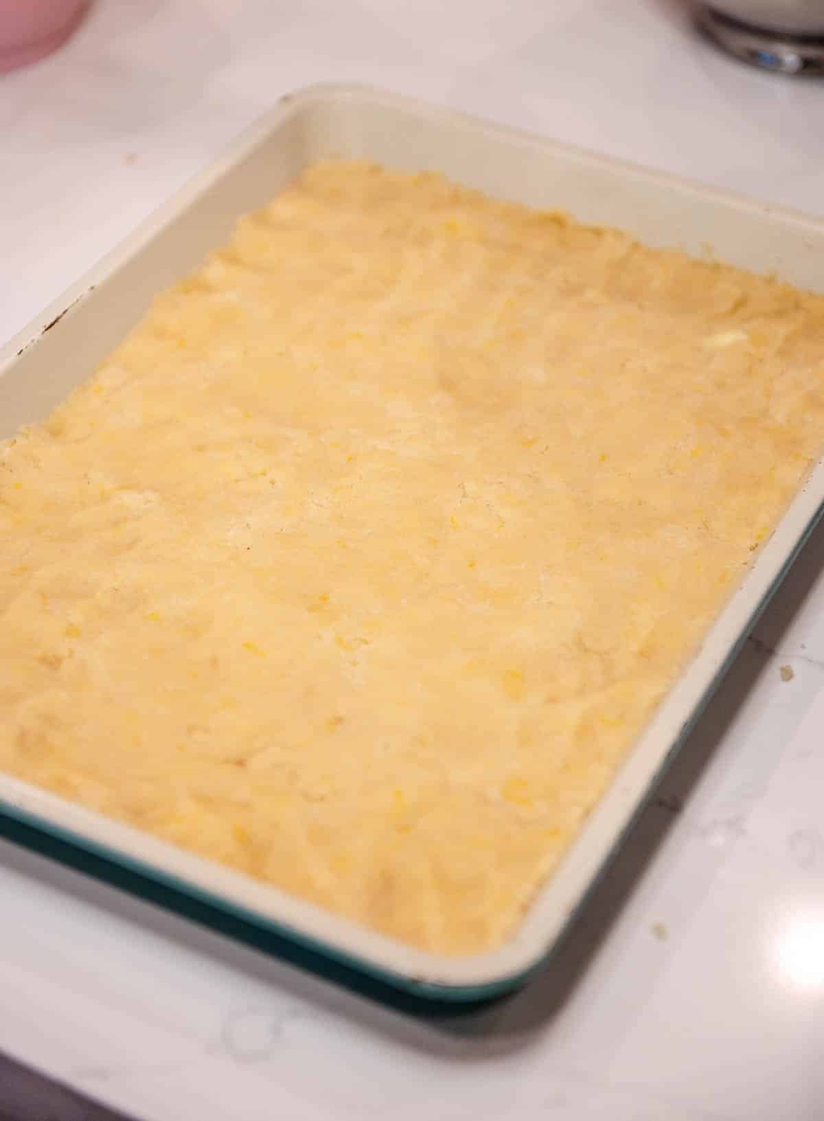 shortbread dough pressed into a sheet pan
