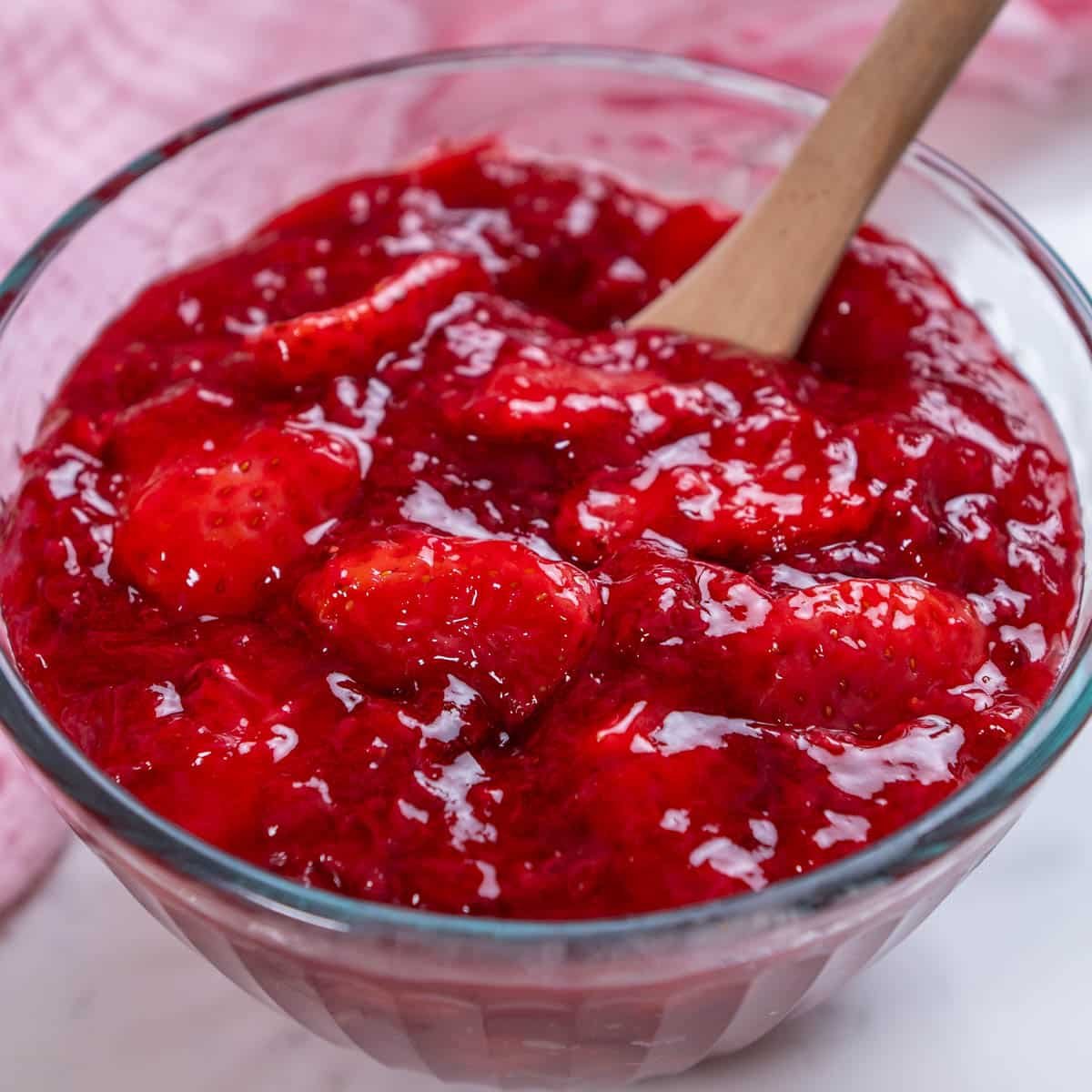 close up of strawberry topping in a glass bowl