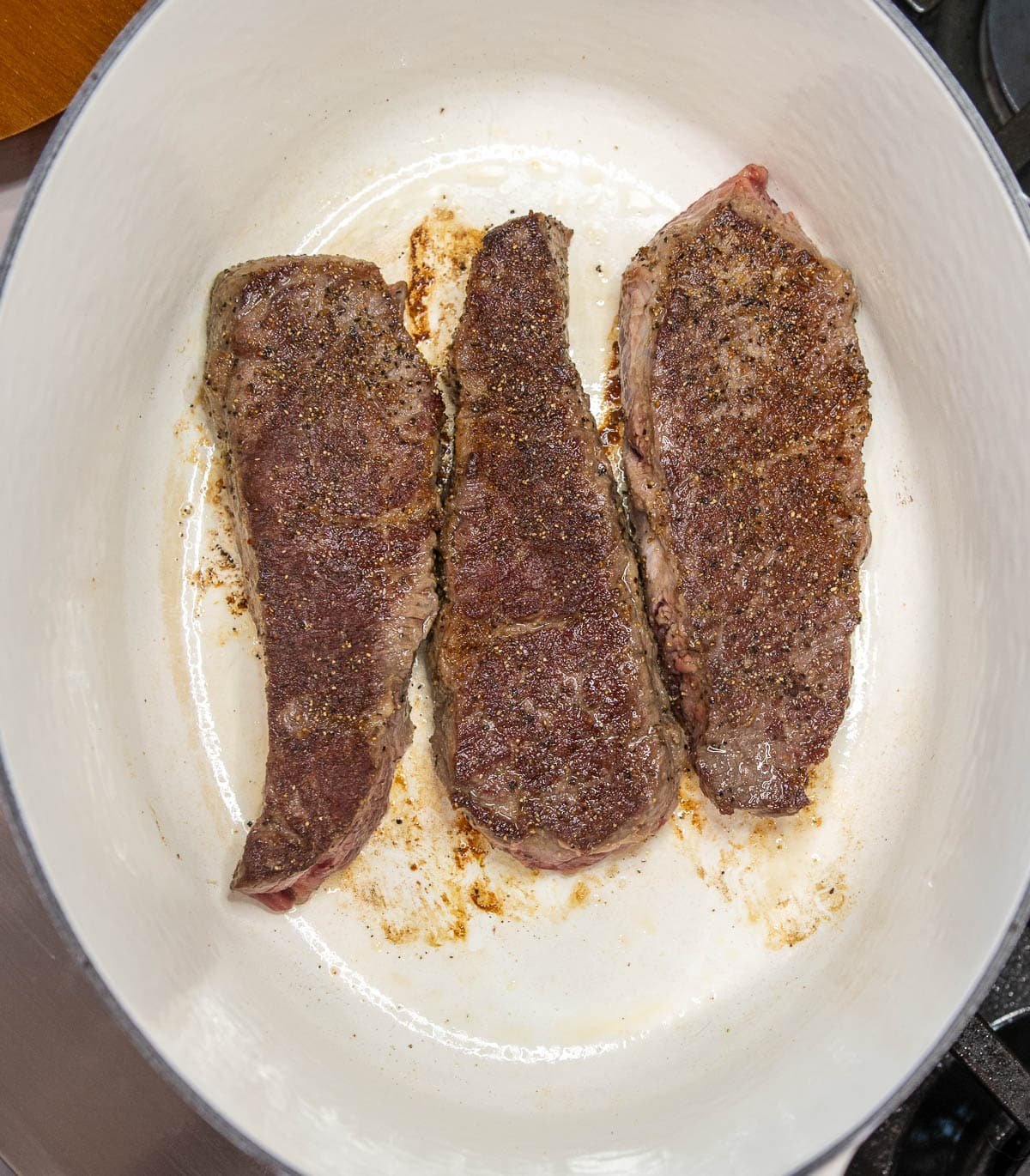 Beef short ribs browning in a dutch oven.