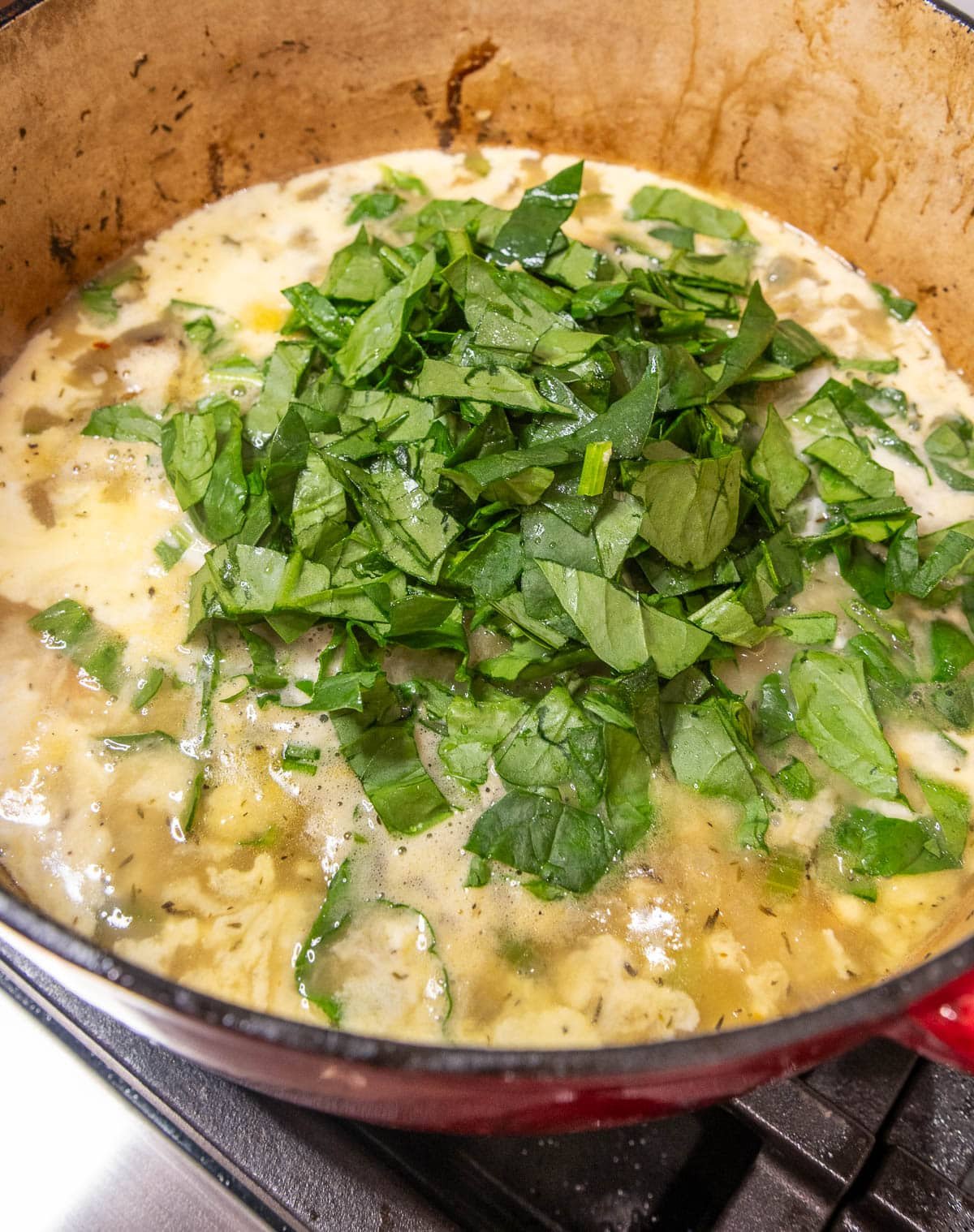 Freshly chopped spinach and heavy cream added to the soup.