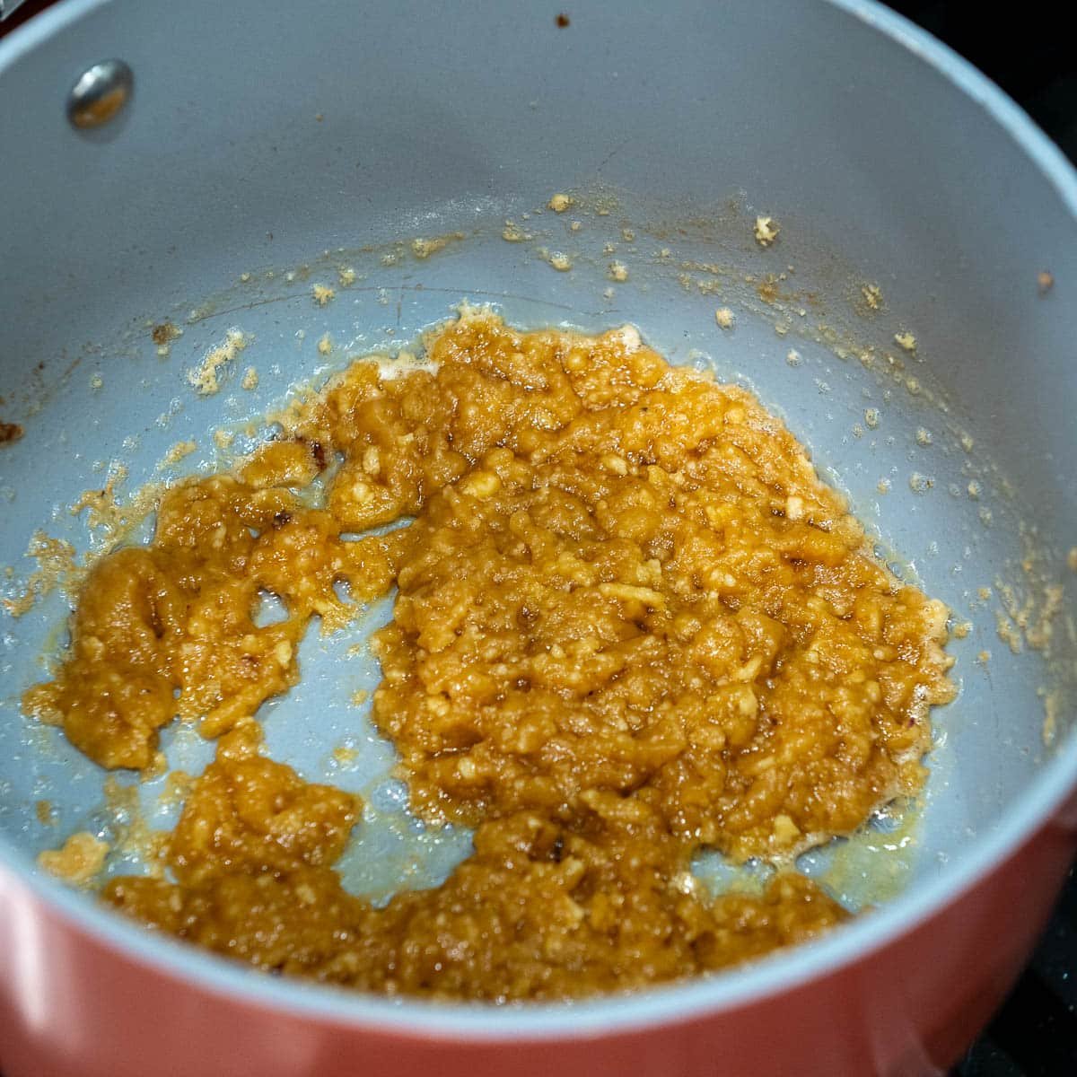 The roux in a pot combined with chicken drippings.