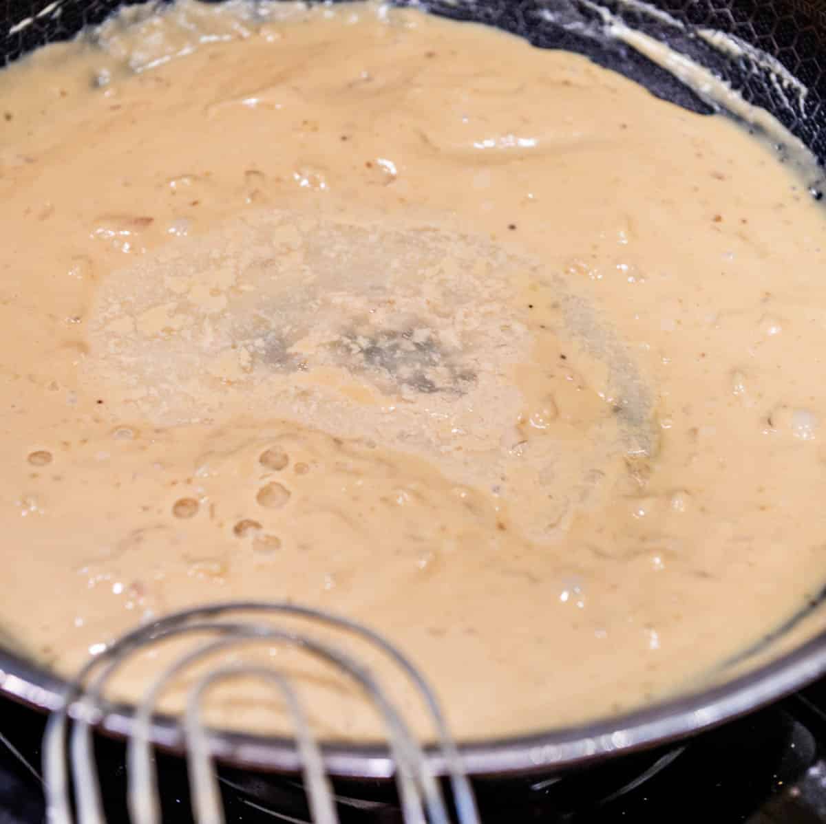 White wine added to the sauce and whisked together. 