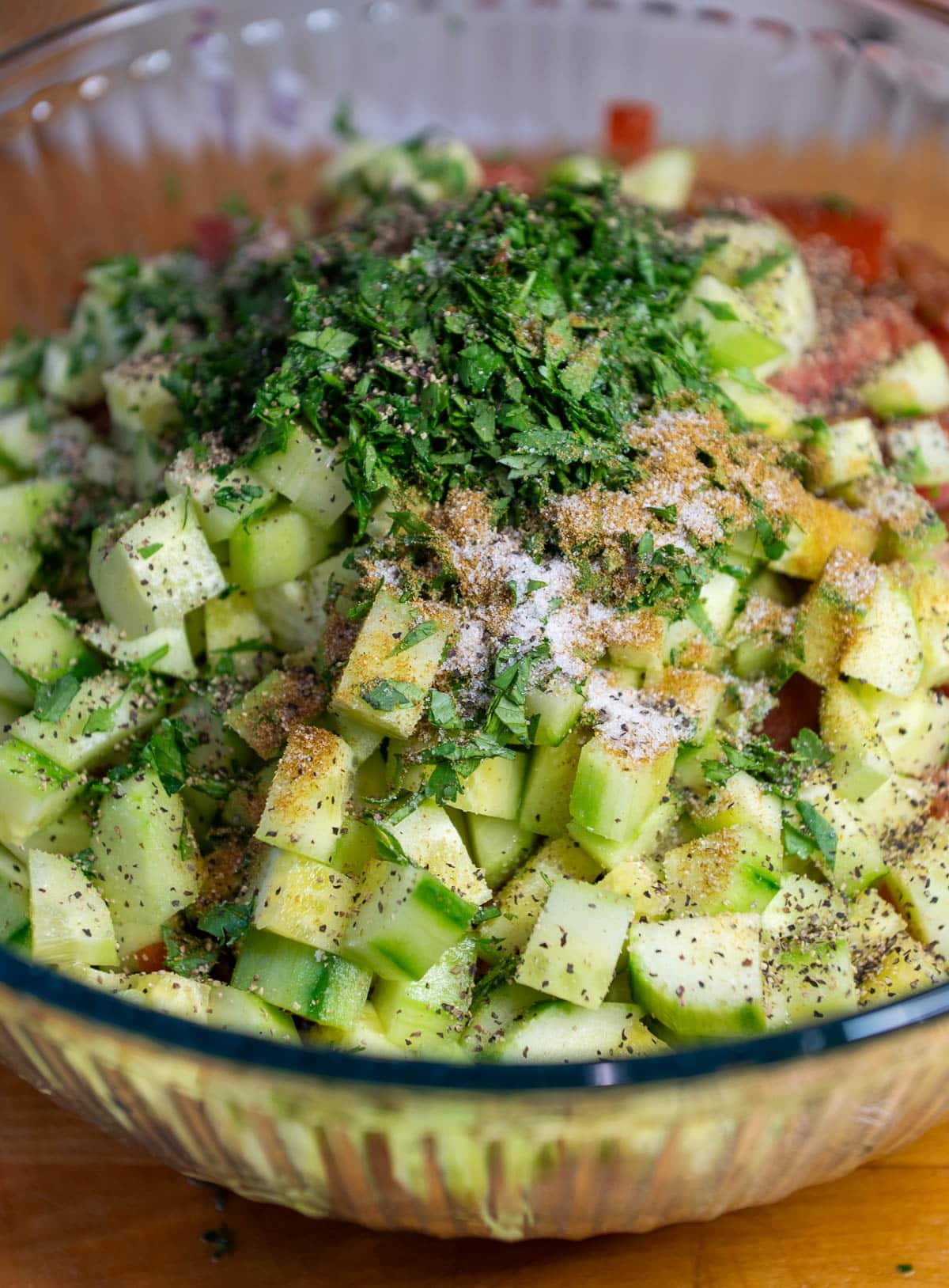 moroccan tomato salad ingredients in a clear bowl