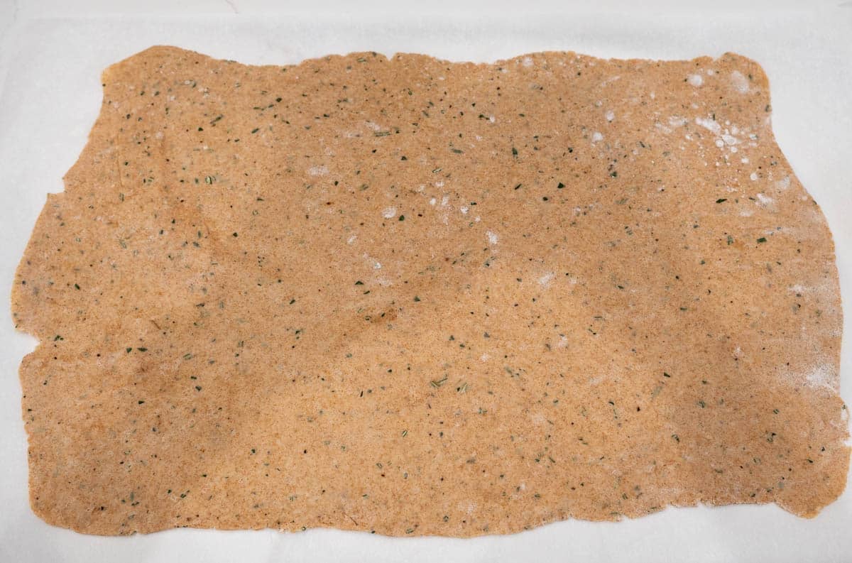 Dough is rolled out on the countertop with flour. 