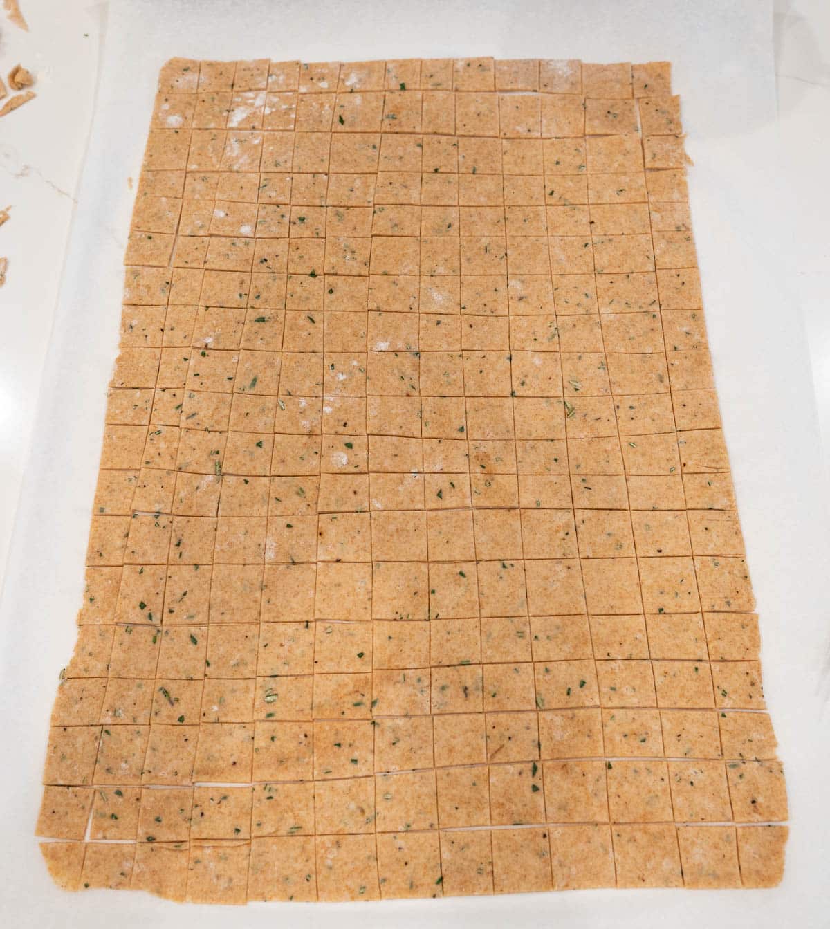 Dough is cut into small squares.