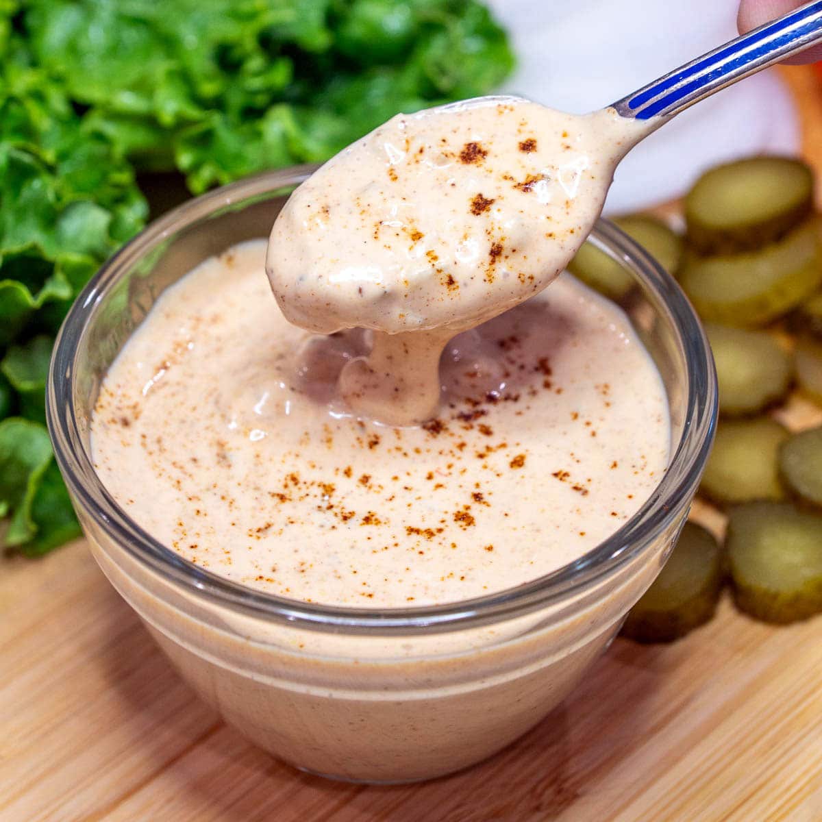 Close-up photo of burger sauce in a small bowl with a spoon.