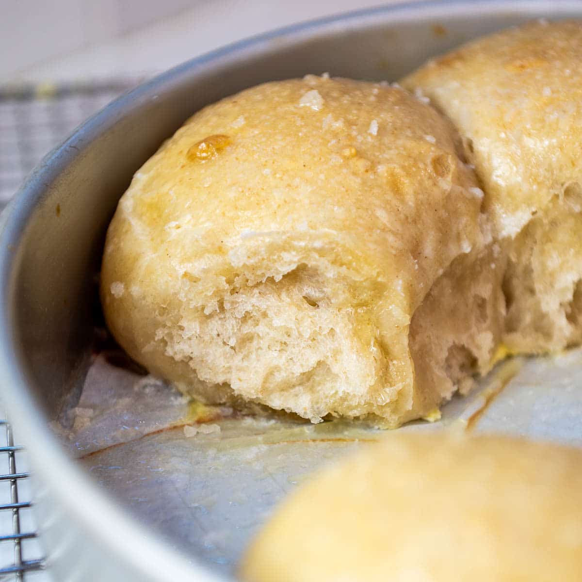 Sourdough rolls in a pan.
