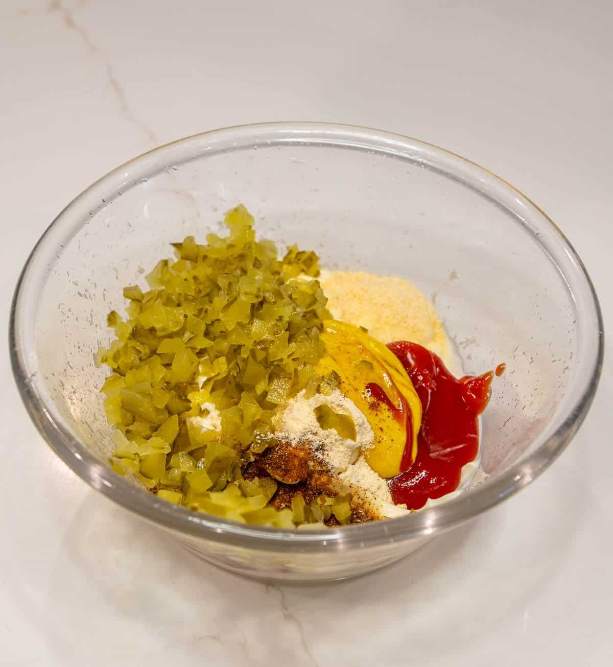 Small glass bowl of ingredients for Burger Sauce. 