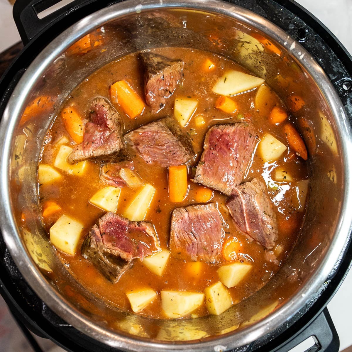 The beef stew as it cooks in the instant pot.