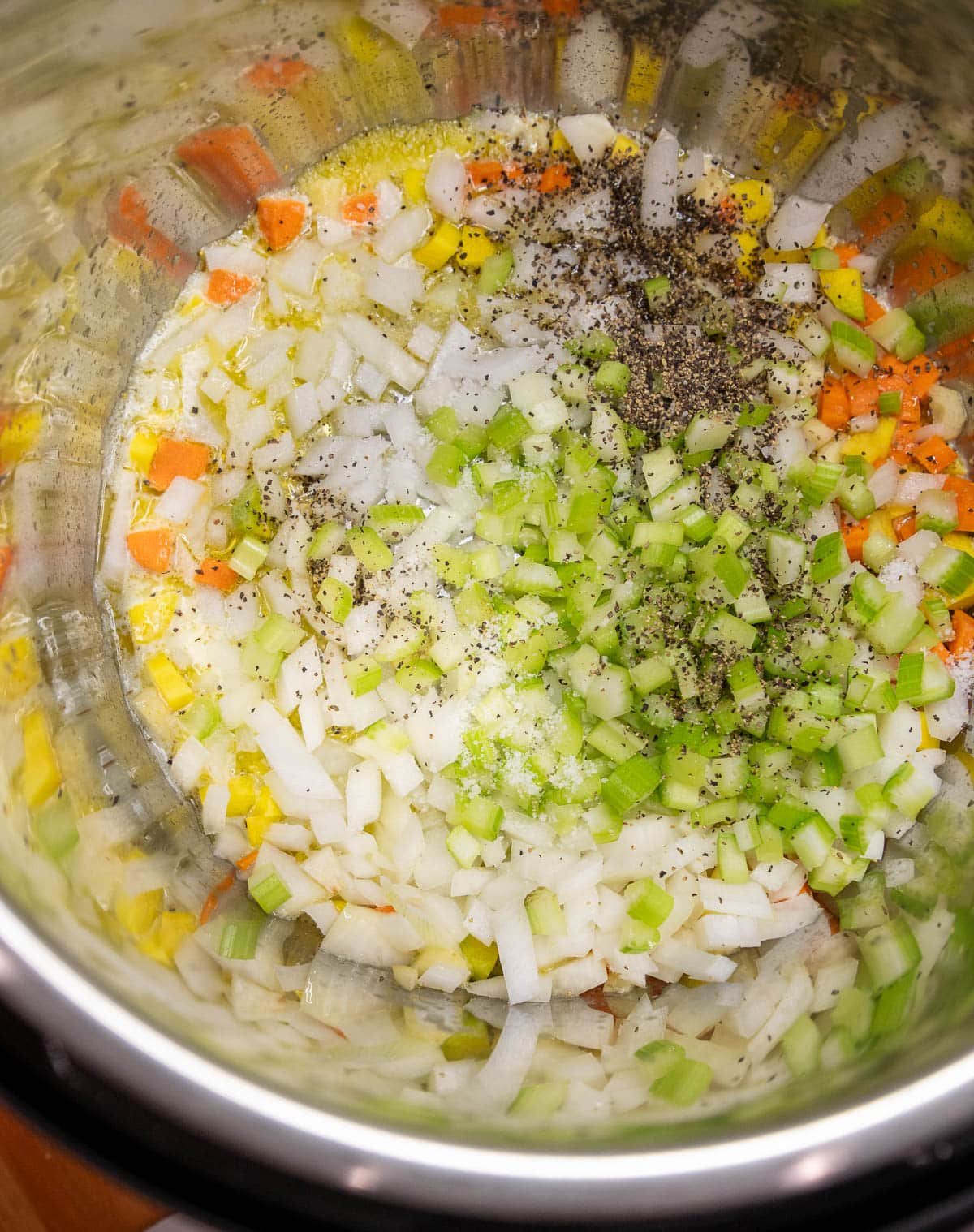 Vegetables and spices are added to the Instant Pot.