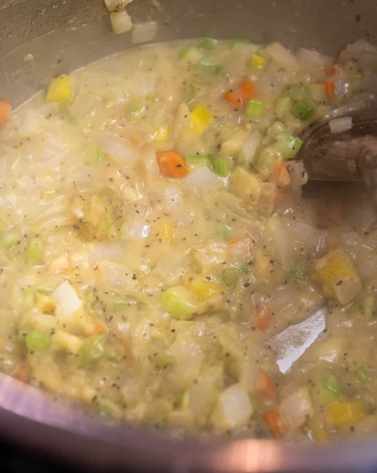 Half of the broth is being stirred in to the mixture.