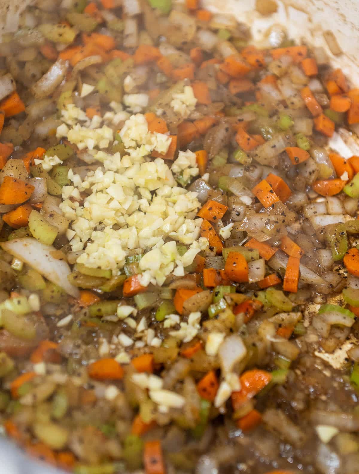 Freshly minced garlic is added to the mirepoix.