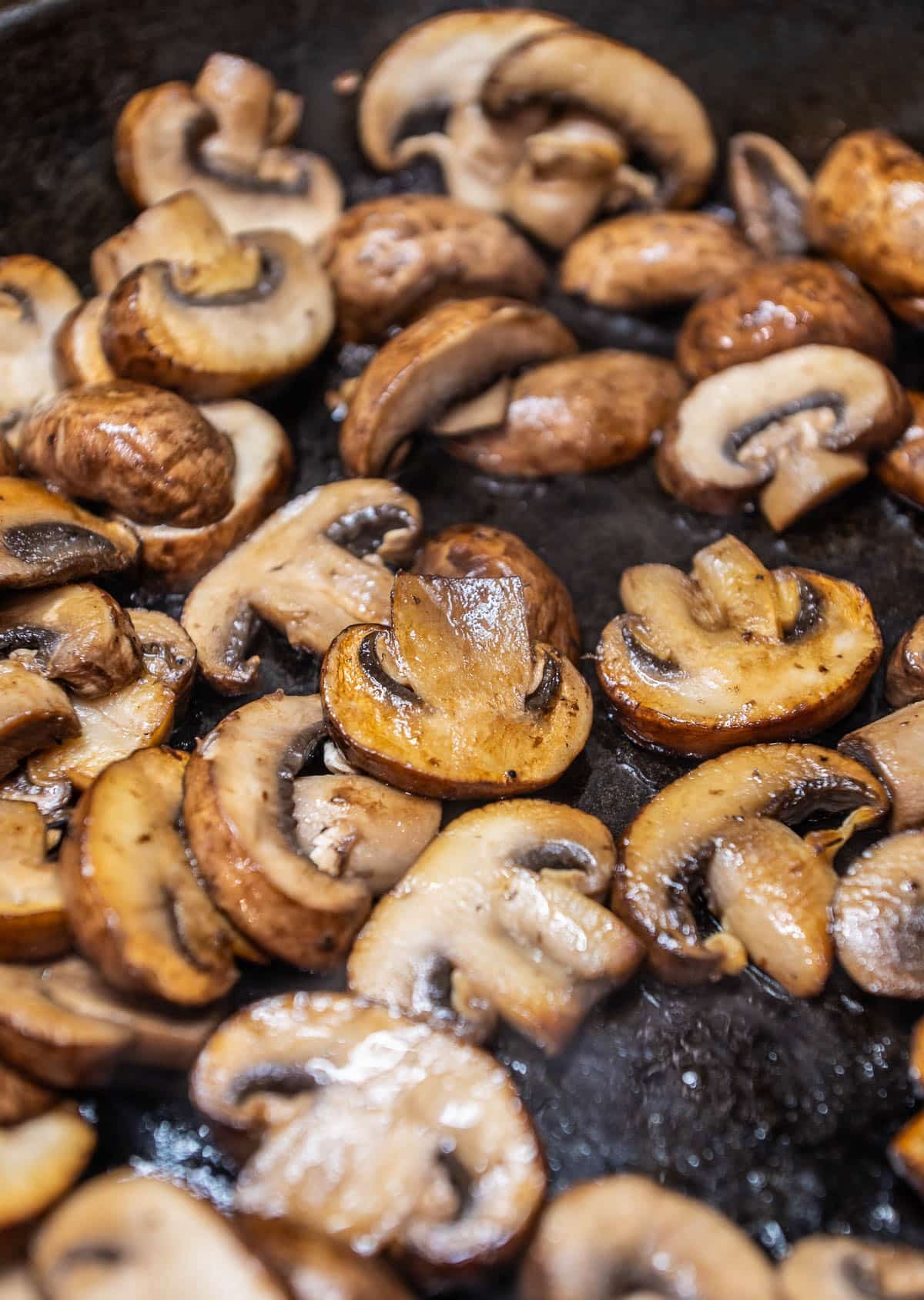 sliced mushrooms browning in a pan
