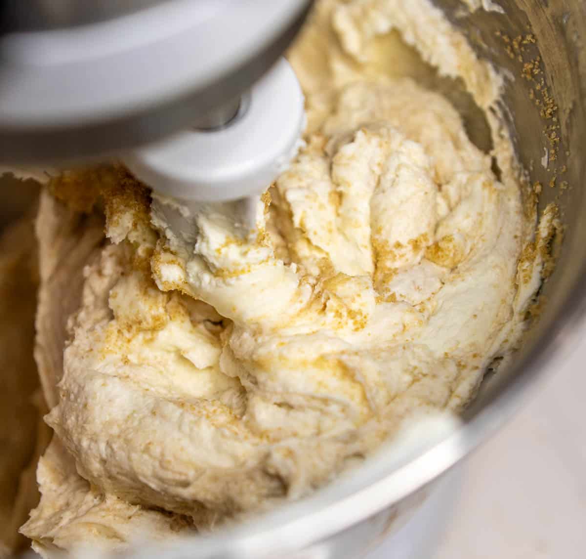 Cream cheese and sugar mixed together using a stand mixer. 