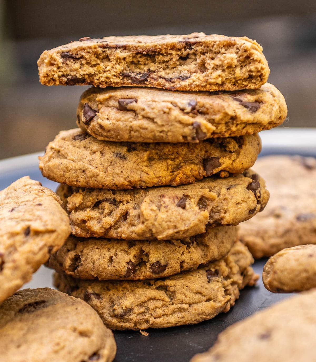 Pumpkin chocolate chip cookies stacked on top of each other. 
